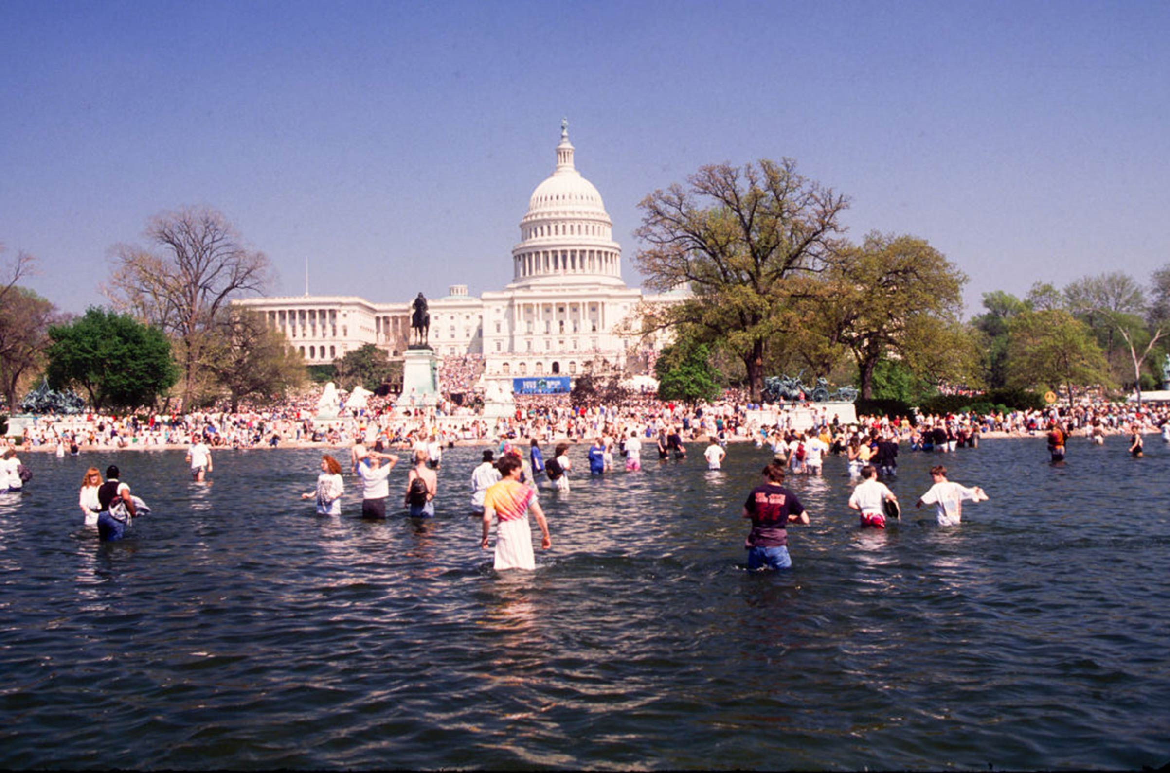 View of the crowd gathering for an Earth Day rally on the U.S. Capitol grounds, some in the Capitol Reflecting Pool on April 22, 1990, in Washington D.C. (Mark Reinstein/Corbis—Getty Images)