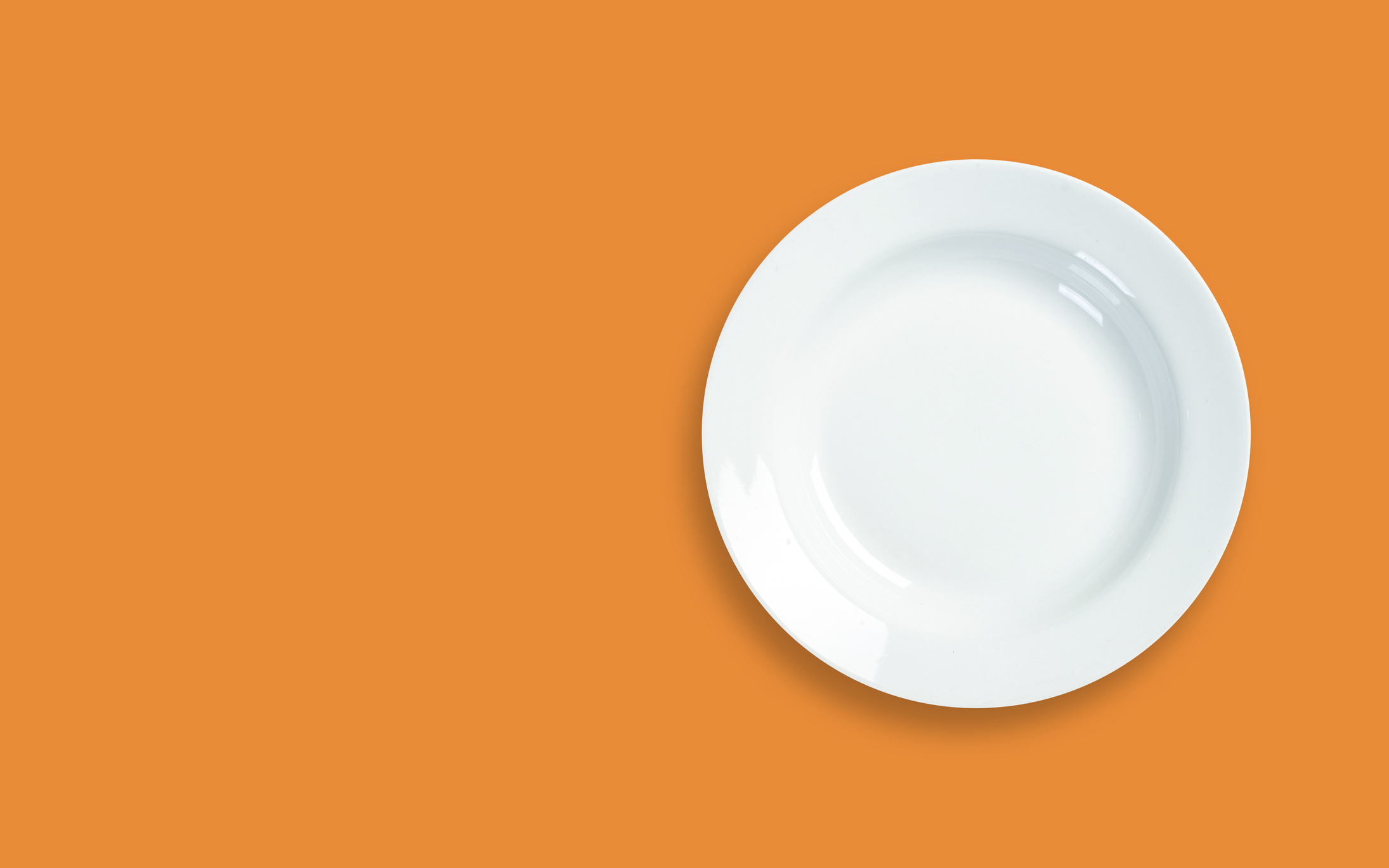 Directly Above Shot Of Empty Plate Over Orange Background