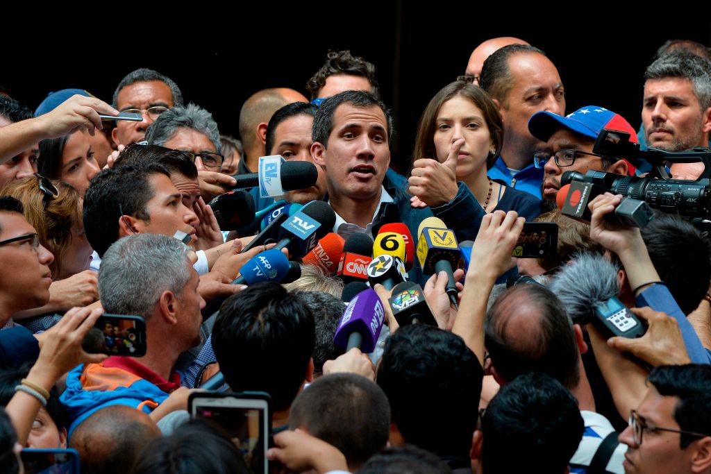 Venezuela's National Assembly head and self-proclaimed "acting president" Juan Guaido (C) speaks to the press after attending a mass in honour to the fallen in the fight for freedom, political prisoners and the exiled, at the San Jose church in Caracas on January 27, 2019. (Luis Robayo– AFP/Getty Images)