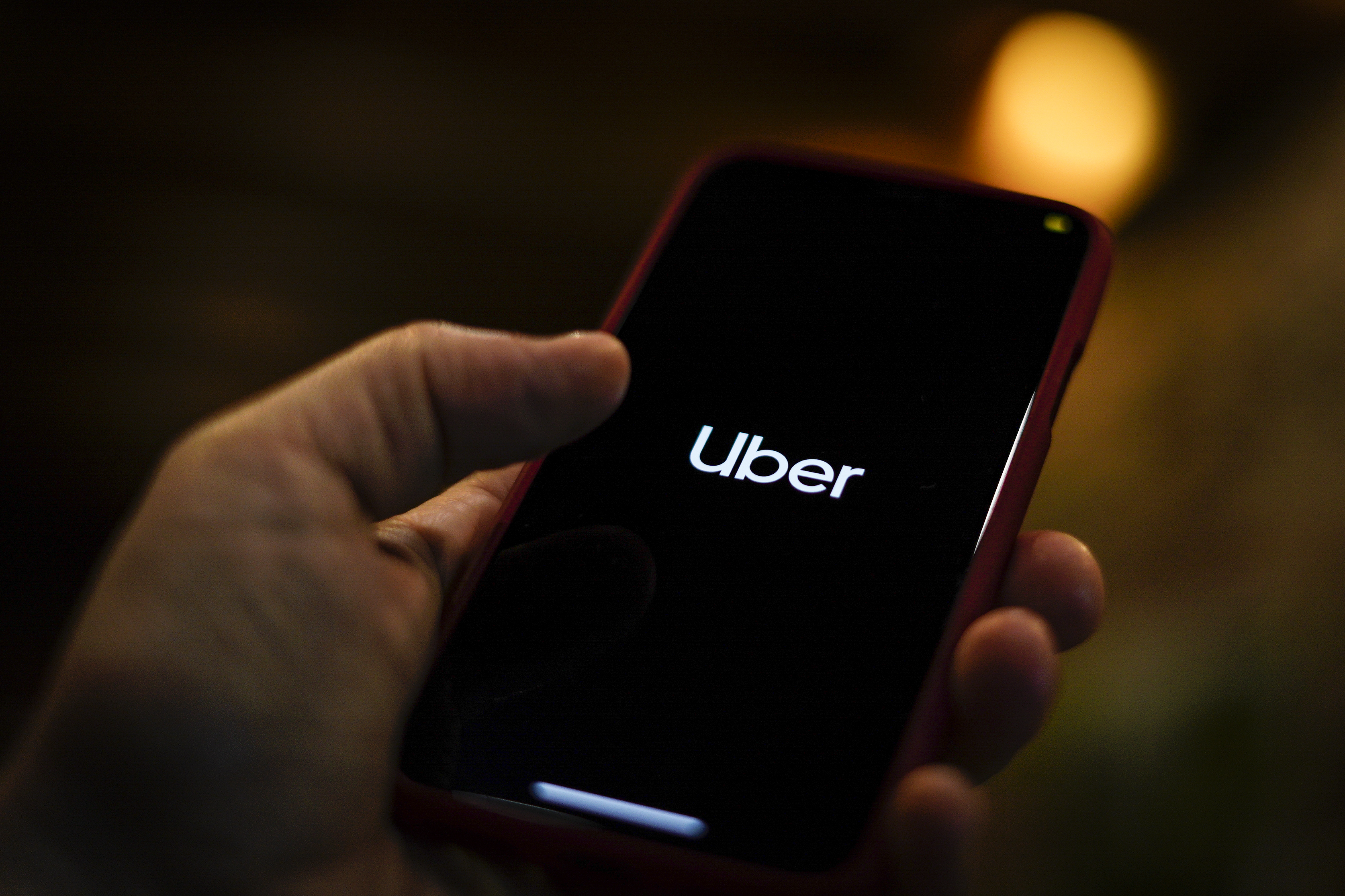 The Uber logo is seen displayed on a mobile device in this photo illustration in Warsaw, Poland on March 19, 2019. (Jaap Arriens—NurPhoto/Getty Images)