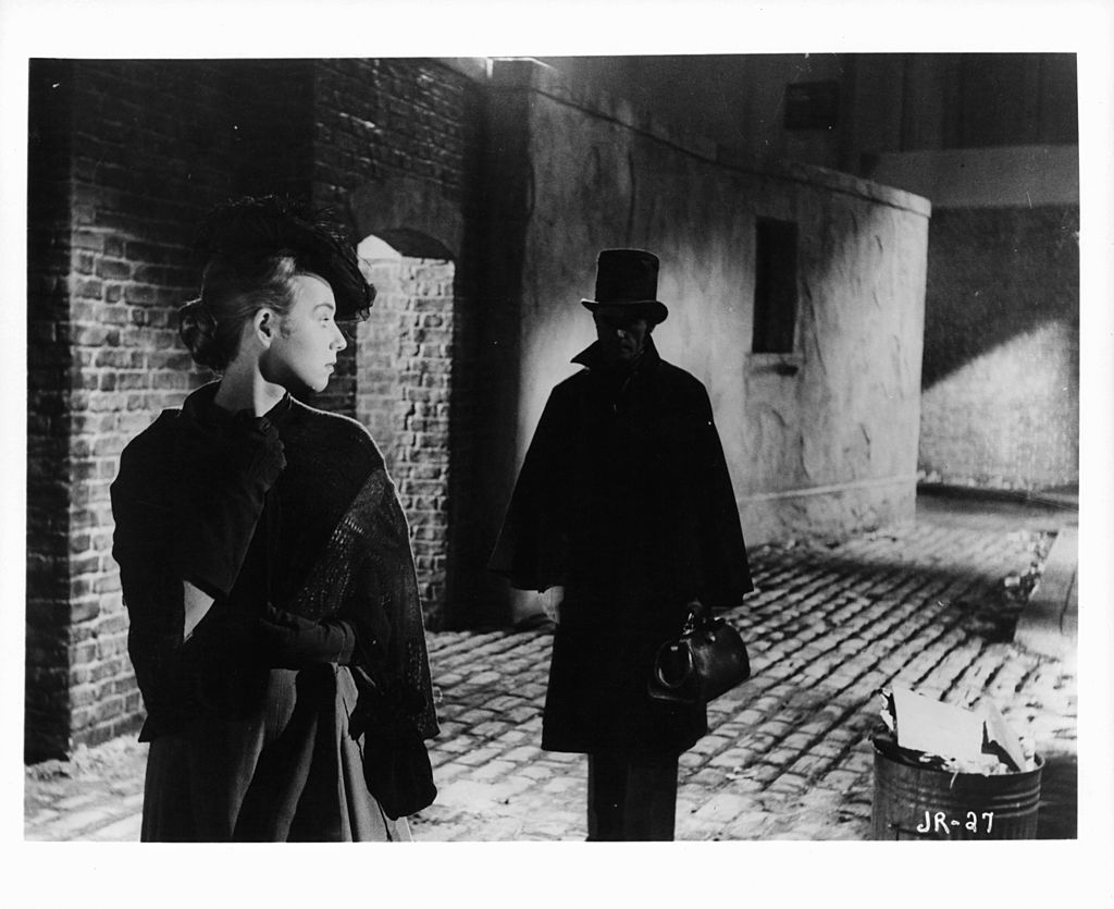 Actress looking back at a man following her in a scene from the film 'Jack The Ripper', 1959. (Archive Photos—Paramount/Getty Images)