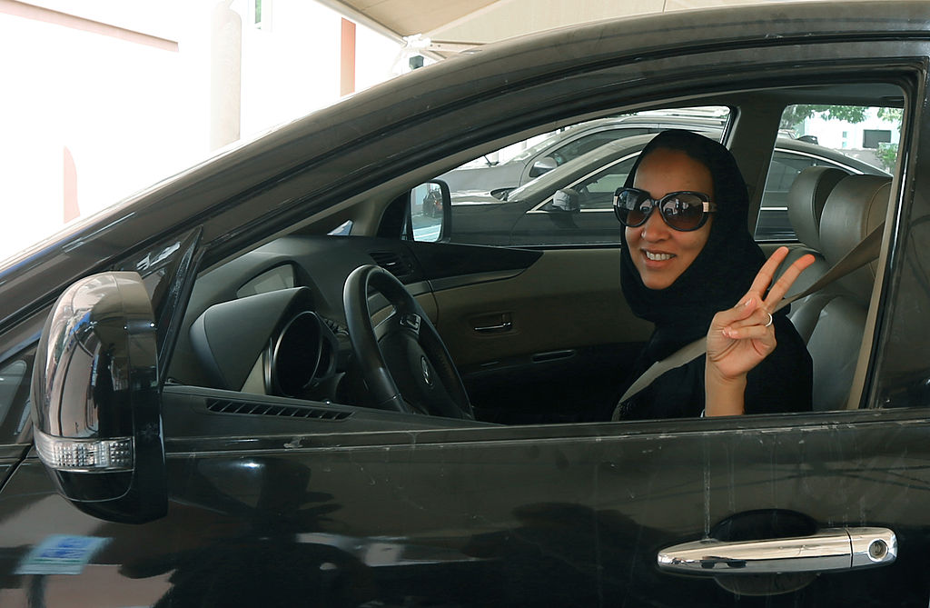 Saudi activist Manal Al Sharif flashes the sign for victory as she drives her car in Dubai on October 22, 2013, in solidarity with Saudi women preparing to take to the wheel on October 26, defying the Saudi authorities, to campaign women's right to drive in Saudi Arabia. (Marwan Naamani—AFP/Getty Images)