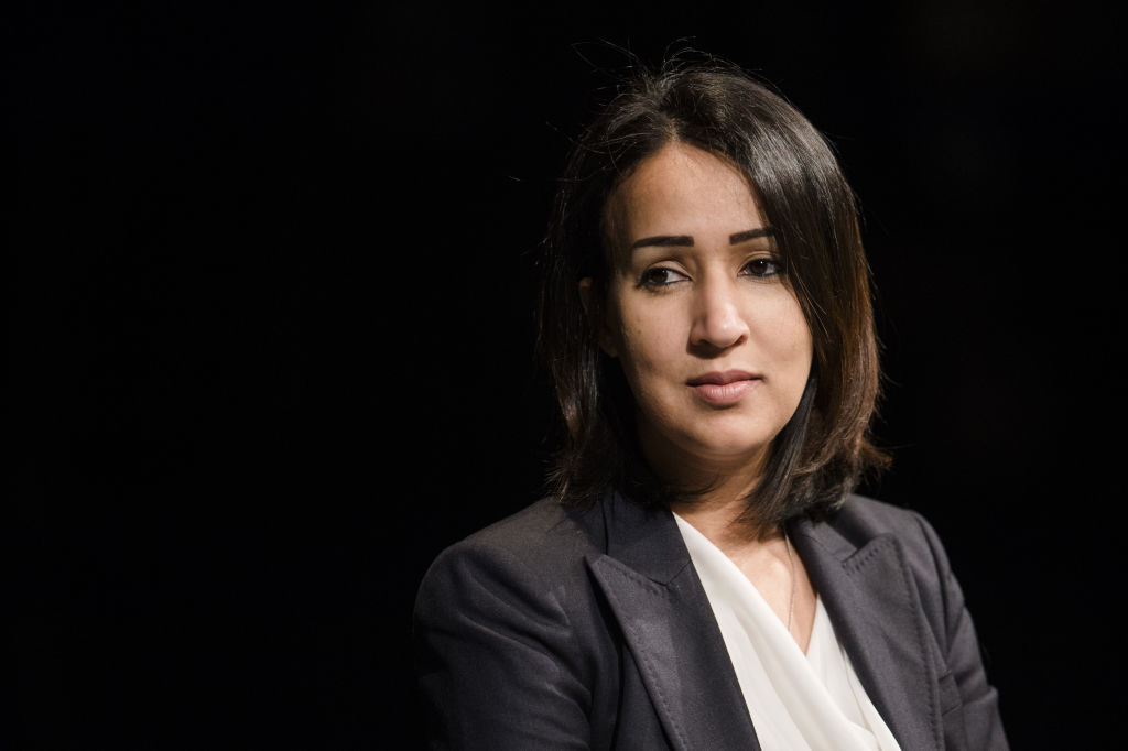 Manal al-Sharif, who in 2011 sat behind the steering wheel of a car in Saudia Arabia despite a driving ban for women, reading from her book "Daring to Drive: A Saudi Woman's Awakening" and talking about her life in the Volkstheater in Munich, Germany, 08 October 2017. (Andreas Gebert —picture alliance/Getty Image)