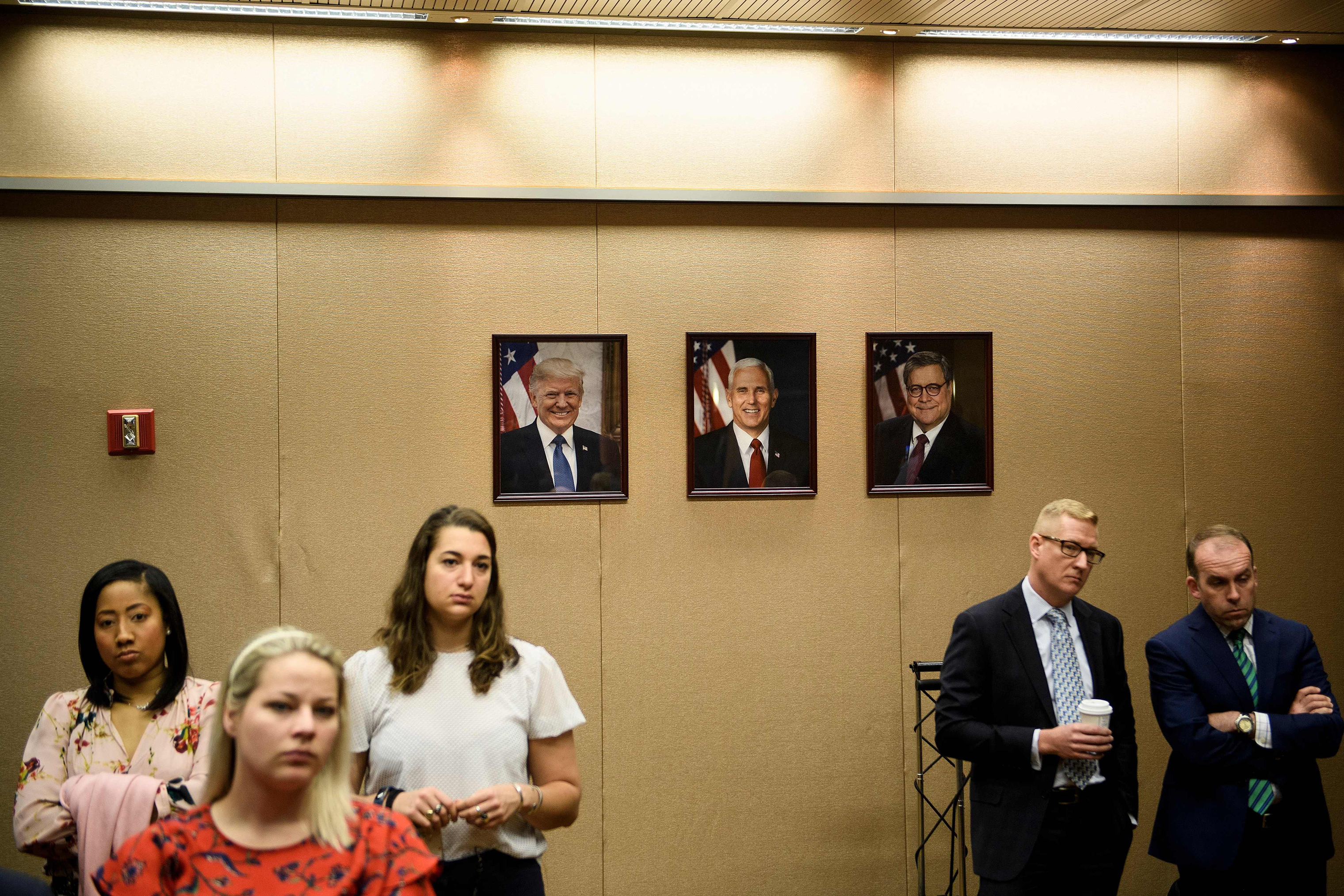 People listen while US Attorney General William Barr holds a press conference about the release of the Mueller Report at the Department of Justice April 18, 2019, in Washington, DC. (Brendan Smialowski—AFP/Getty Images)