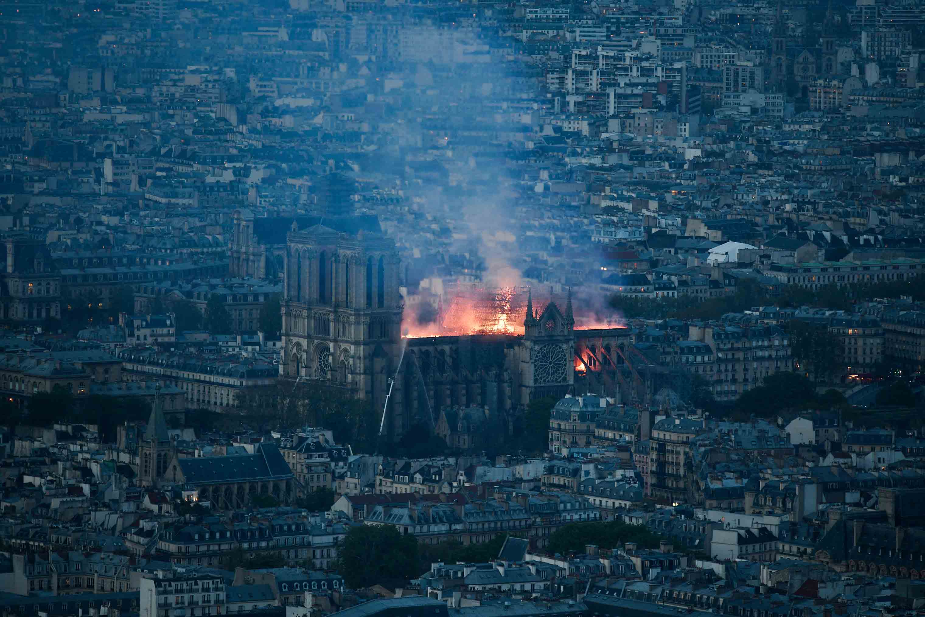 Smoke and flames rise during a fire at the landmark Notre-Dame Cathedral in central Paris on April 15, 2019. (Stephane Rochon Vollet—Abaca/SIPA)