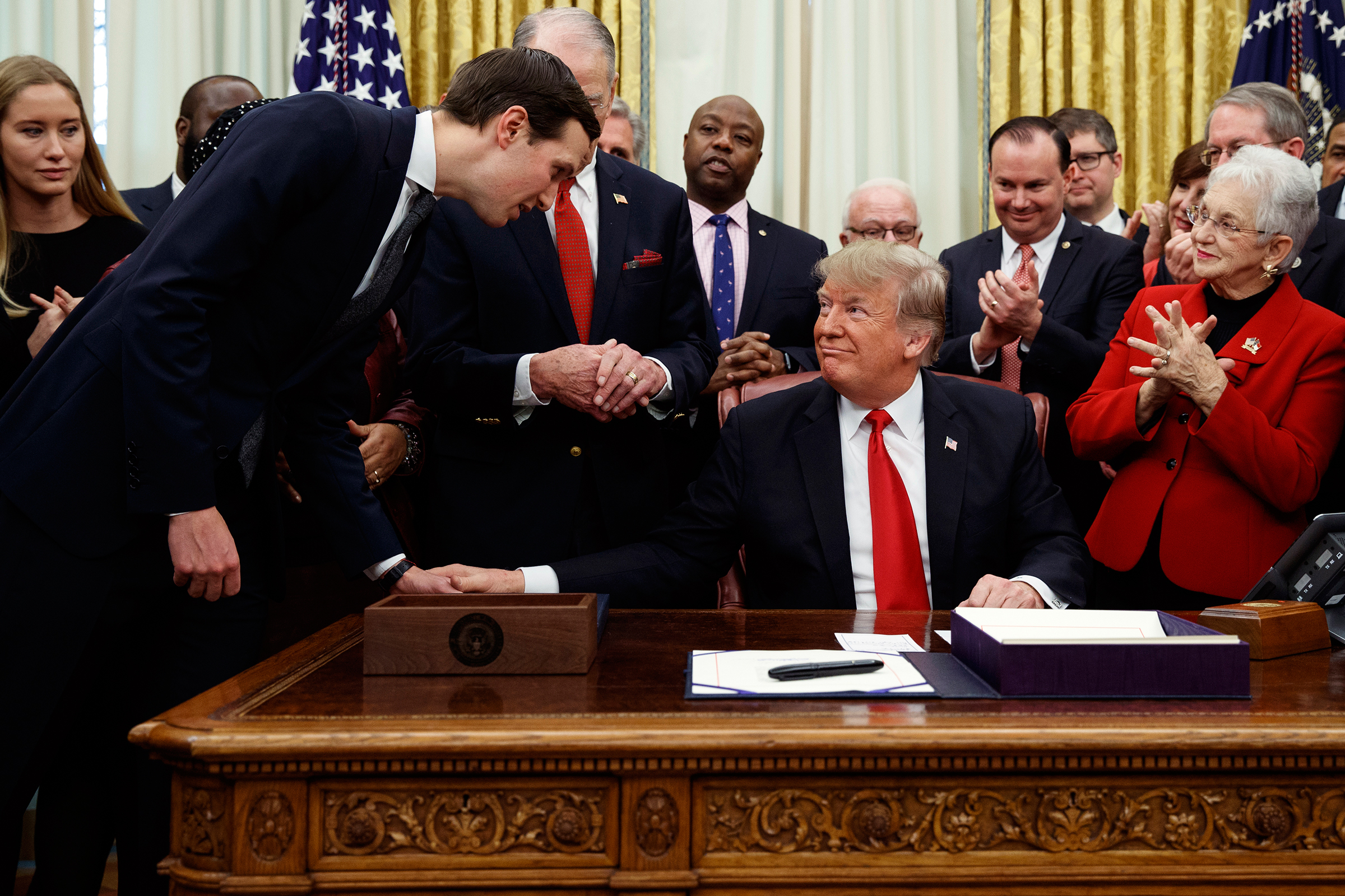 White House senior adviser Jared Kushner talks with President Donald Trump during a signing ceremony for criminal justice reform legislation in the Oval Office of the White House, Dec. 21, 2018.