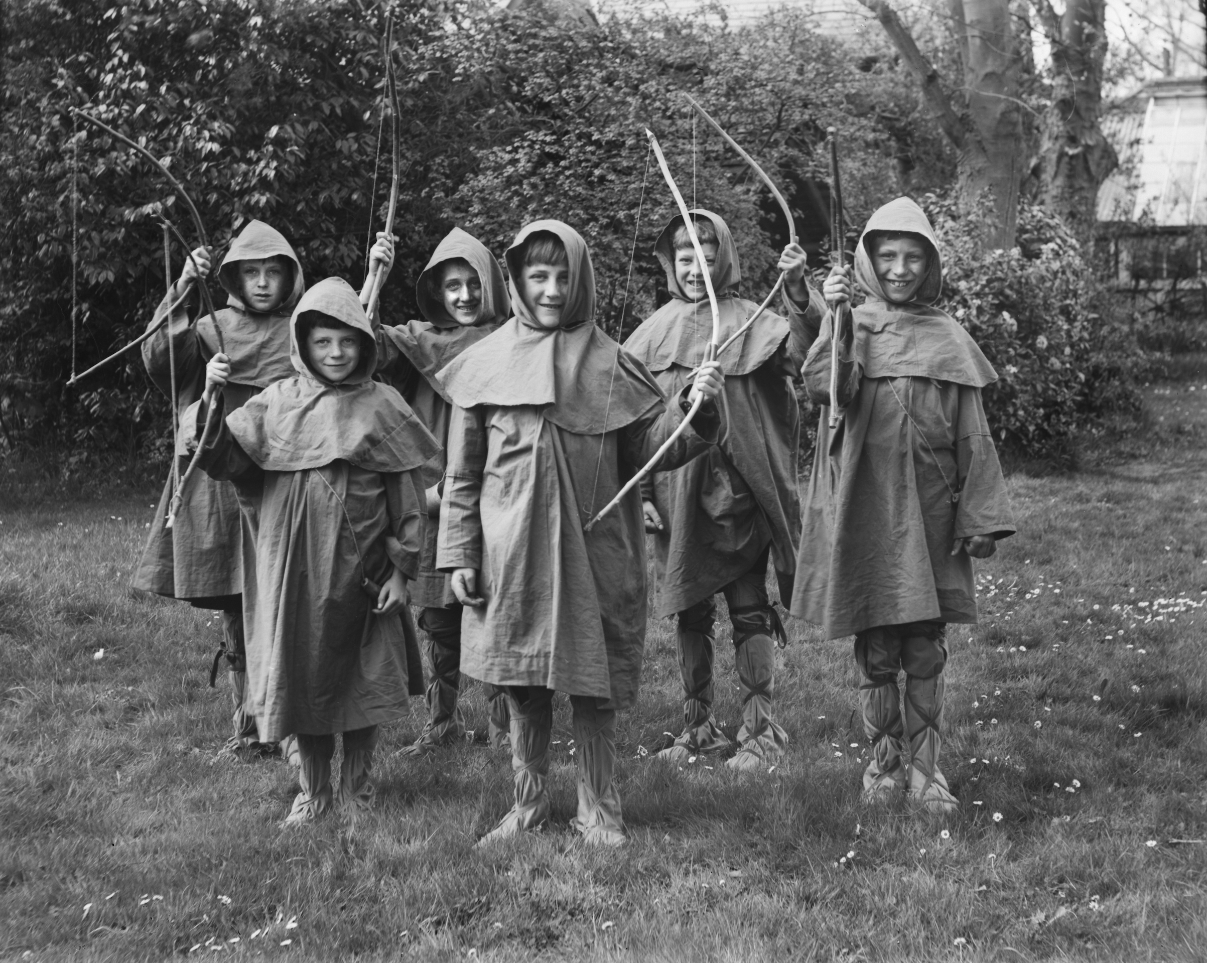 A group of school boys dressed as Robin Hood hold up their bows, U.K. ca. 1920. (Kirn Vintage Stock/Corbis via Getty Images)