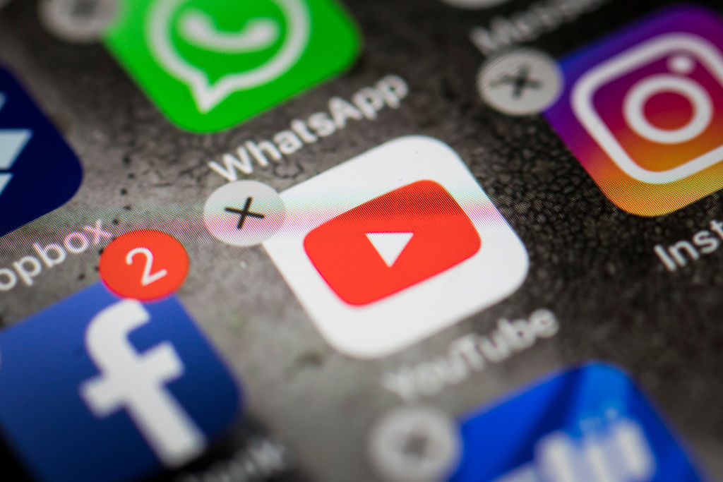 YouTube, Facebook, Instagram and WhatsApp logos are seen on a smartphone in Berlin, Germany, on March 26, 2019. (Florian Gaertner—Photothek/Getty Images)