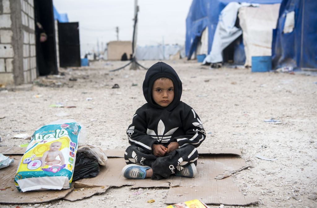 A displaced Syrian boy sits in front of tents and makeshift homes at a refugee camp in Al-Hol, northeastern Syria, on Feb. 6, 2019. (Fadel Senna—AFP/Getty Images)