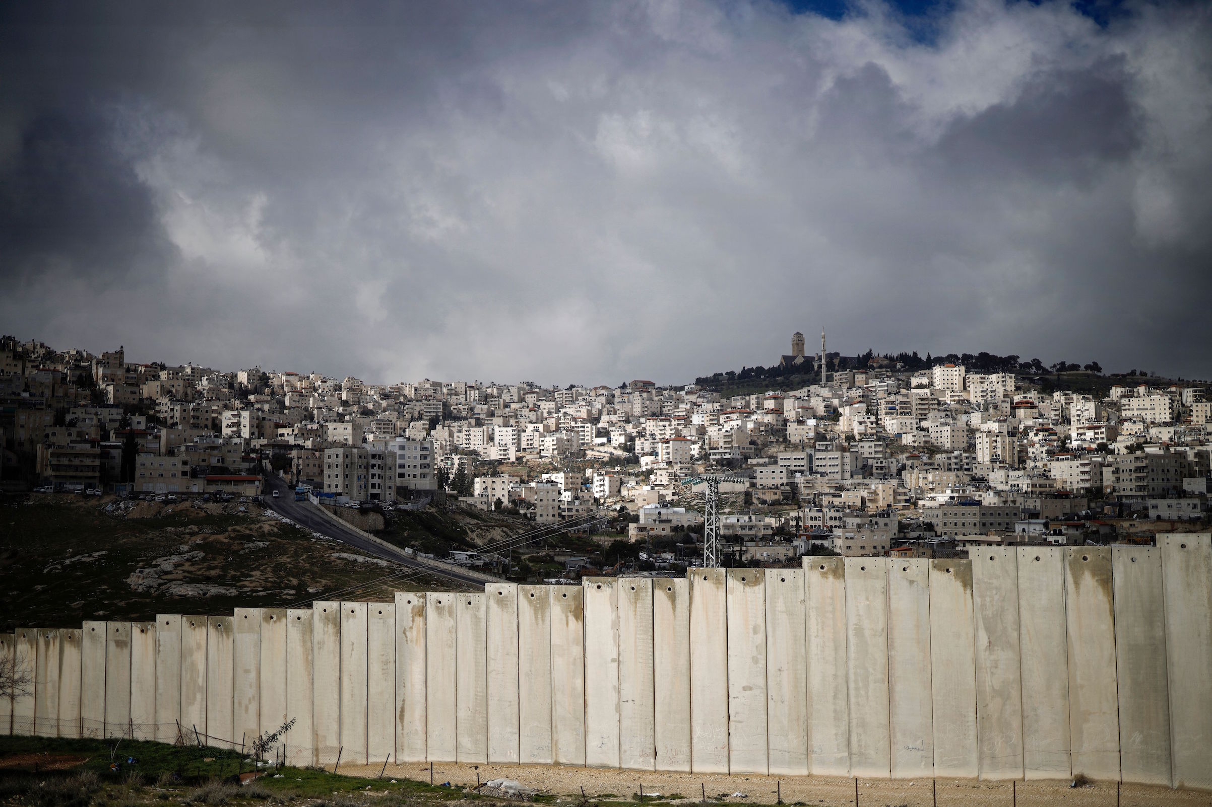 This picture taken on Jan. 17, 2019, shows the controversial barrier separating the Palestinian West Bank village of Eizariya (foreground) and Jerusalem (background). (Thomas Coex—AFP/Getty Images)