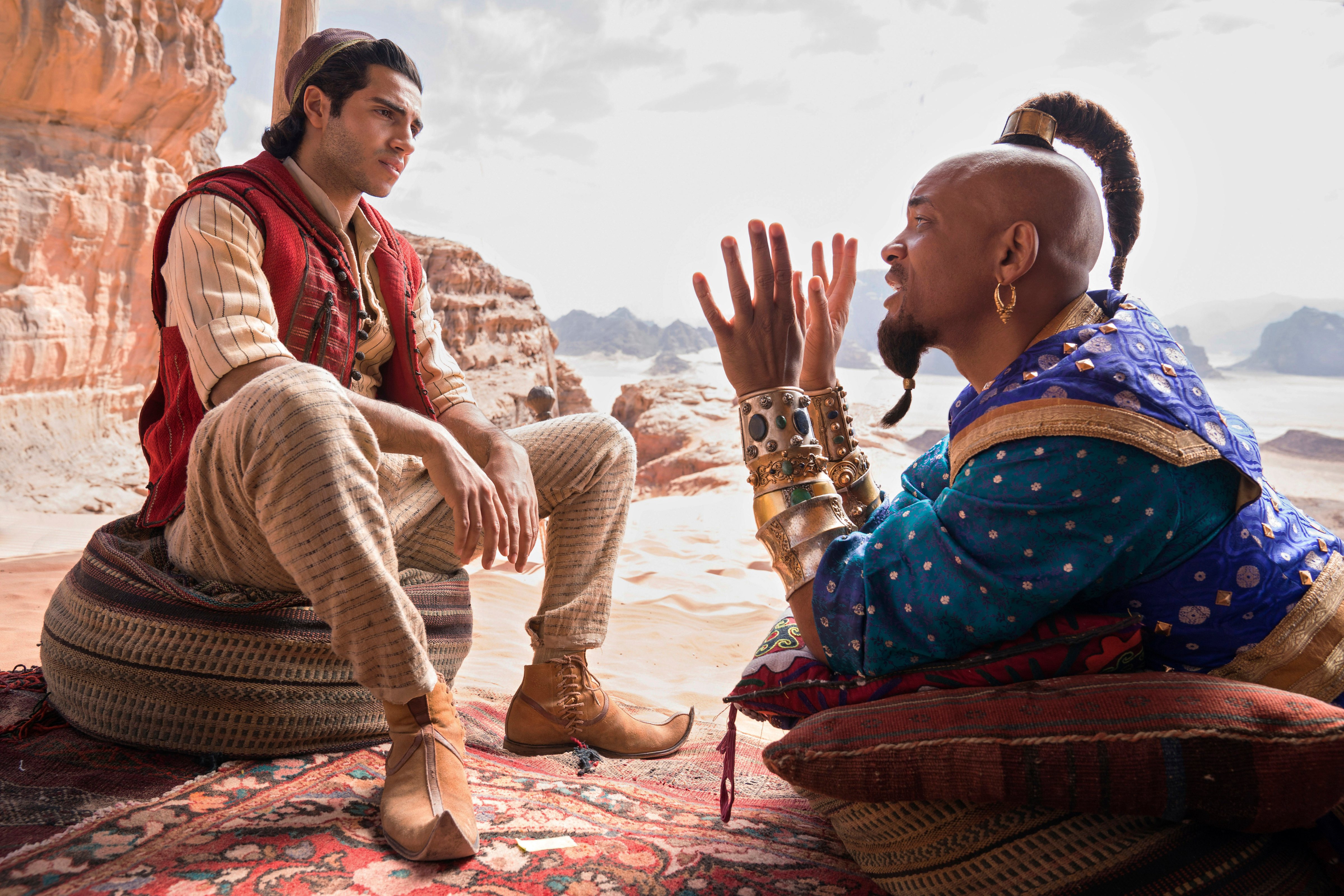 This image released by Disney shows Mena Massoud as Aladdin, left, and Will Smith as Genie in Disney's live-action adaptation of the 1992 animated classic 'Aladdin.' (Daniel Smith—Disney/AP)