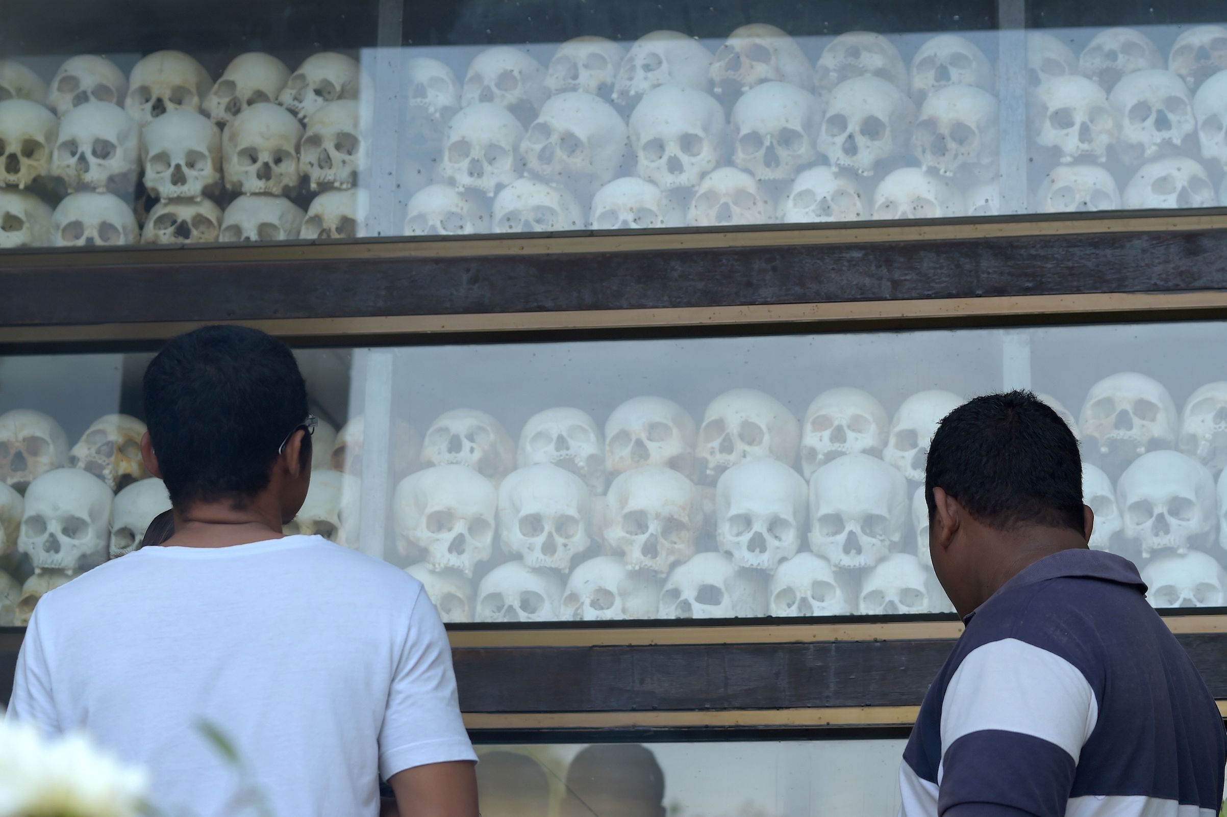 People look at skulls at the Choeung Ek memorial in Phnom Penh on May 20, 2018, as Cambodians observed the annual remembrance day (TANG CHHIN SOTHY&mdash;AFP/Getty Images)