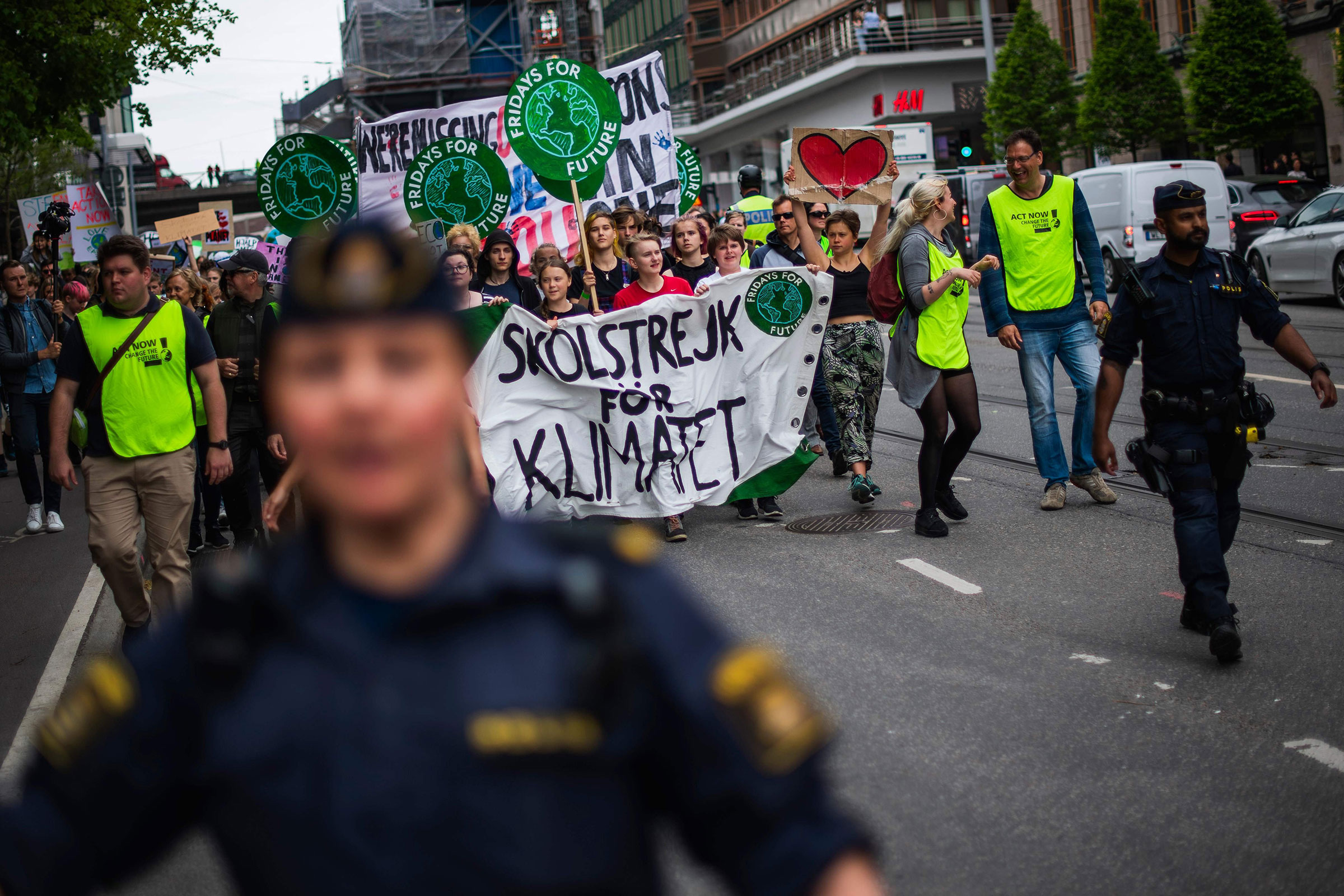 Greta Thunberg (2ndL behind the banner), the 16-year-old Swedish climate activist, marches during the "Global Strike For Future" movement