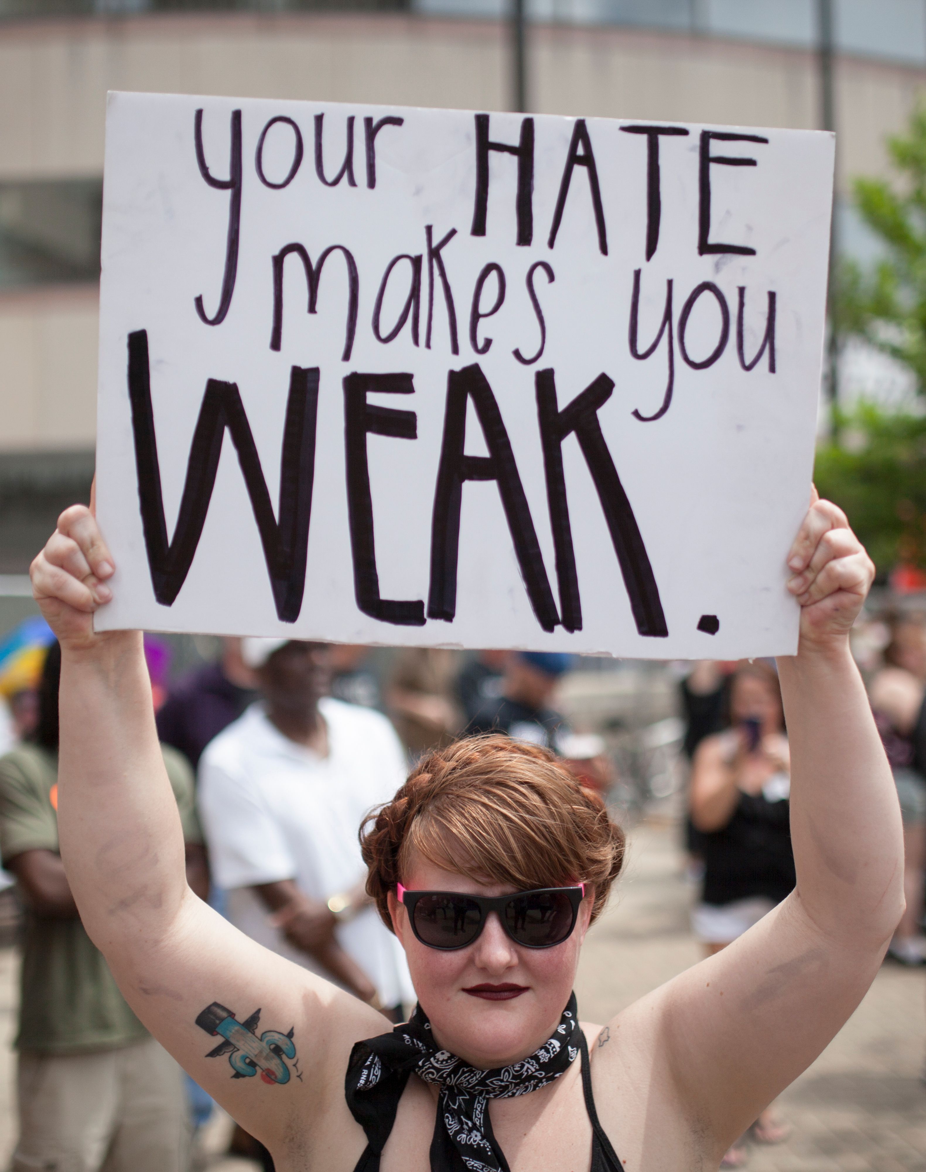 An anti-Klan protestor holds a sign at a small rally of a KKK-affiliated group that gathered in Dayton, Ohio, on May 25, 2019. (SETH HERALD—AFP/Getty Images)