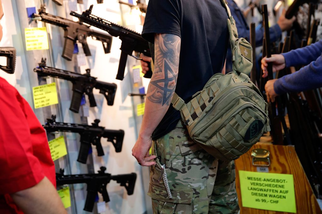 A visitor holds a gun during the 45th edition of the Arms Trade Fair, in Lucerne, Switzerland on March 29, 2019 (Stefan Wermuth—AFP/Getty Images)