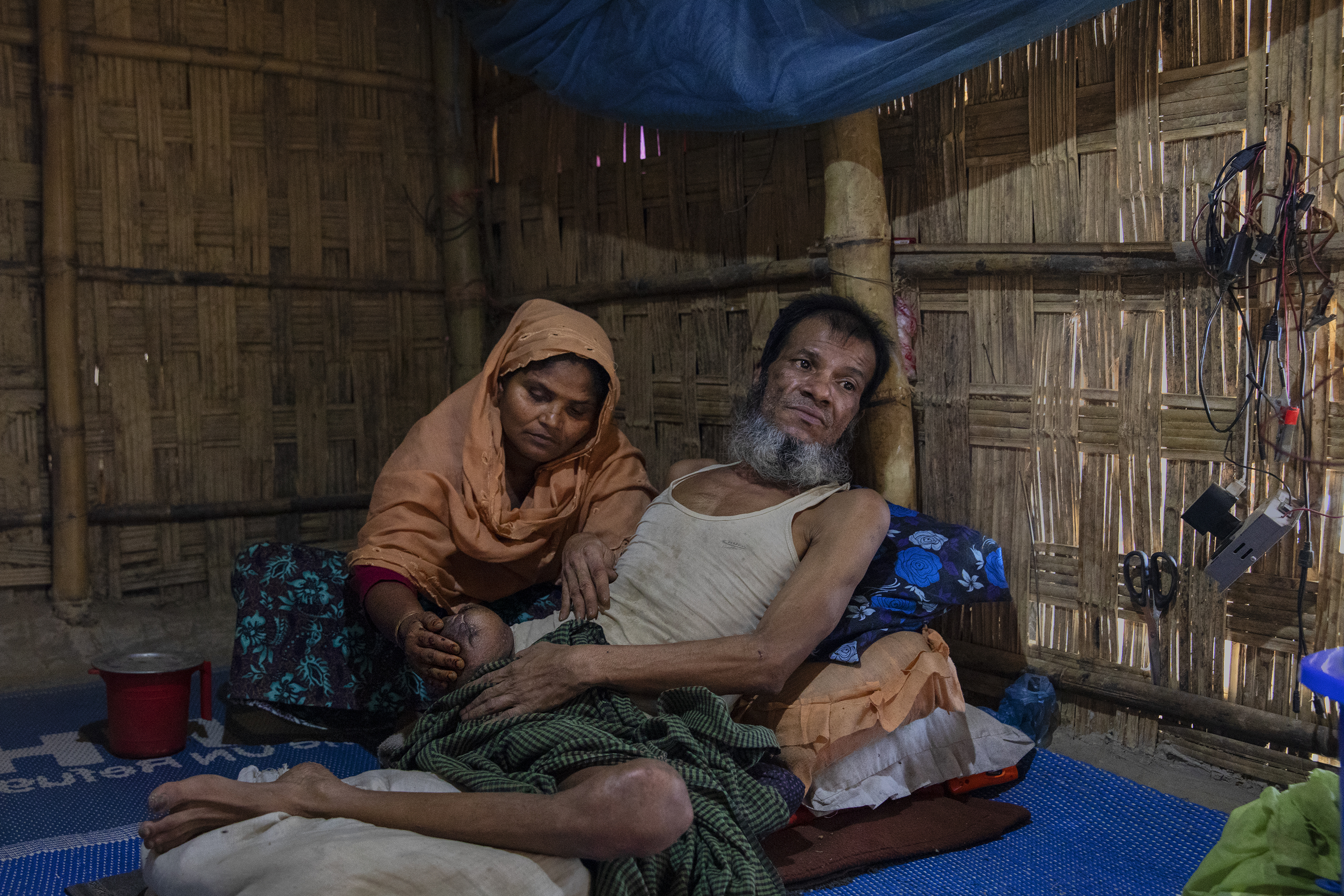 Inan Hossein, with his wife Halema Khatun, lost his leg to a gunshot from a government soldier in Myanmar. (James Nachtwey for TIME)