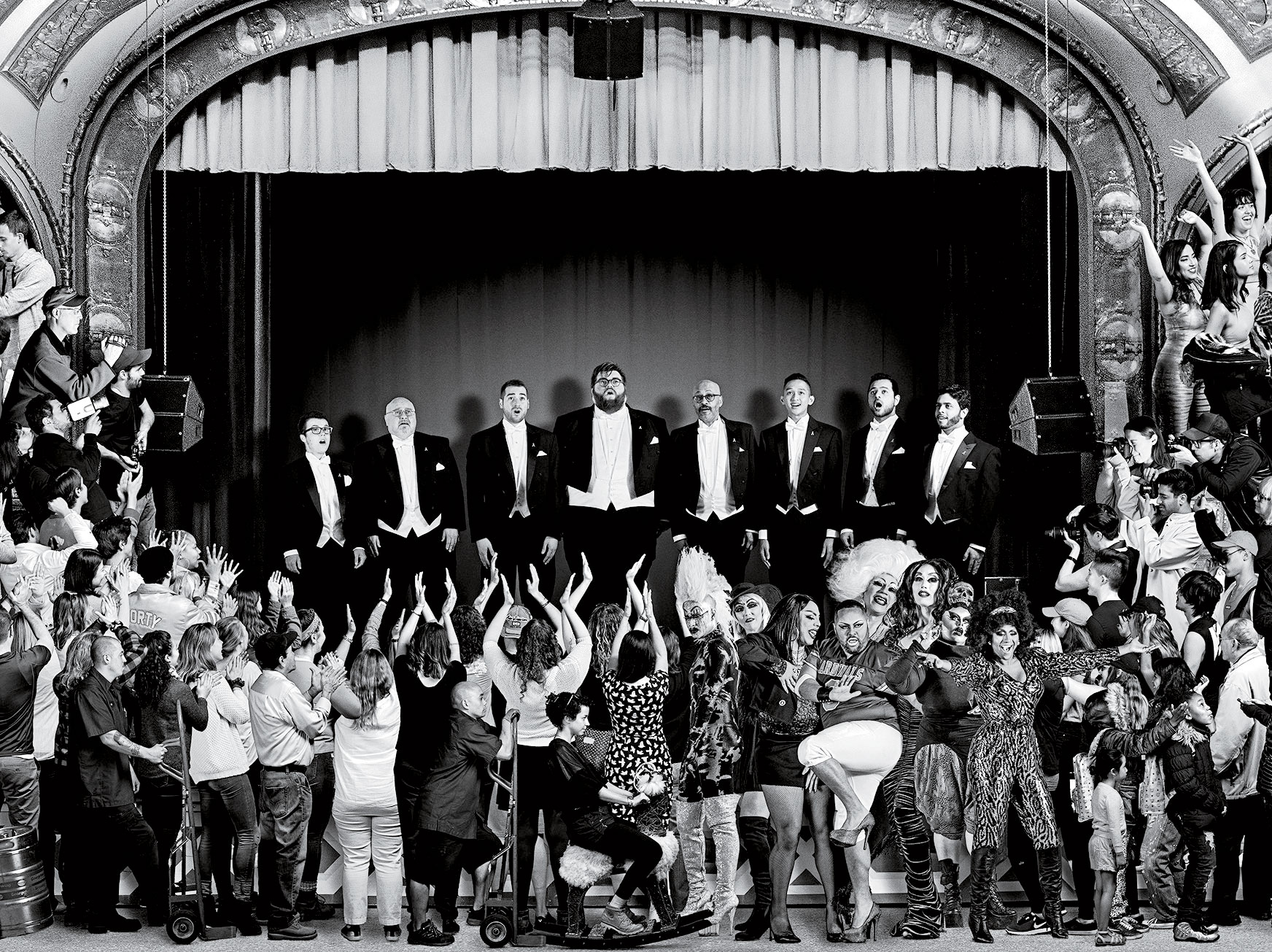This photo shows one section of JR's new mural, The Chronicles of San Francisco. In the digital version, which was painstakingly compiled from videos he and his team made of individuals—and, in some cases, groups—figures move slowly. Some are even transported. On the stage above, for instance, members of the San Francisco Gay Men’s Chorus take a bow and the curtain falls. The curtain then rises to reveal other performers, such as a group doing a traditional Chinese lion dance, a nod to strong Asian immigrant communities in the city. (JR)