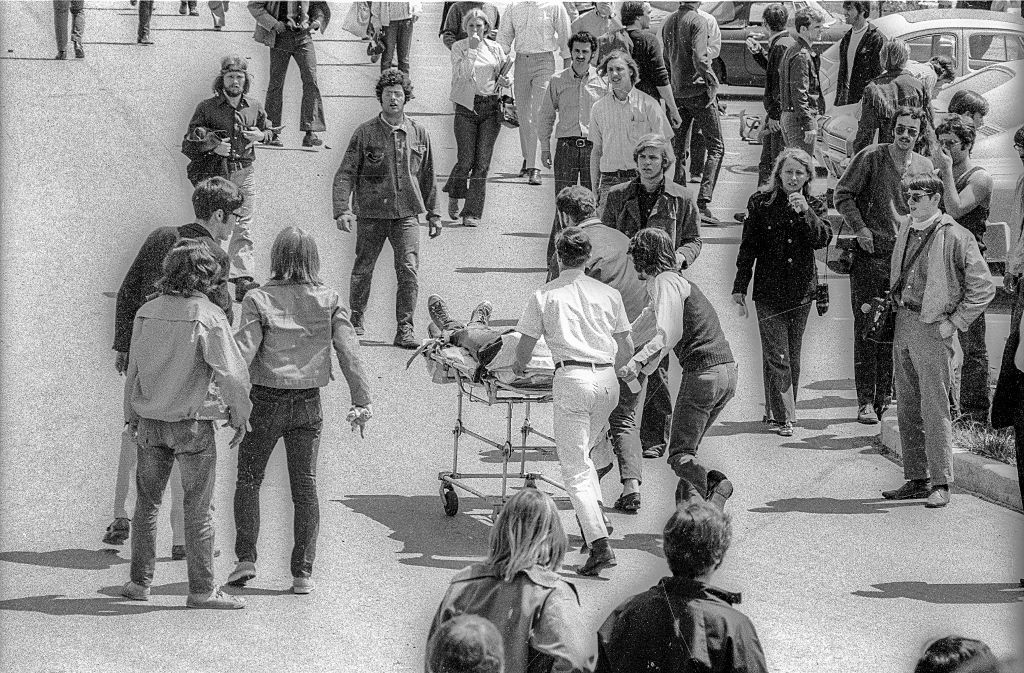Paramedics and students run as they push the body of Kent State University student Jeffrey Miller (1950 - 1970) on a gurney after he'd been shot when the Ohio National Guard opened fire on antiwar protesters, Kent, Ohio, May 4, 1970. (Howard Ruffner—Getty Images)
