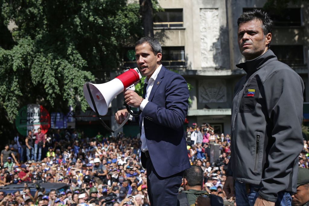 Venezuelan opposition leader and self-proclaimed acting president Juan Guaido (C) speaks to supporters next to high-profile opposition politician Leopoldo Lopez, who had been put under home arrest by Venezuelan President Nicolas Maduro's regime, and members of the Bolivarian National Guard who joined his campaign to oust Maduro, in Caracas on April 30, 2019. (CRISTIAN HERNANDEZ&mdash;AFP/Getty Images)