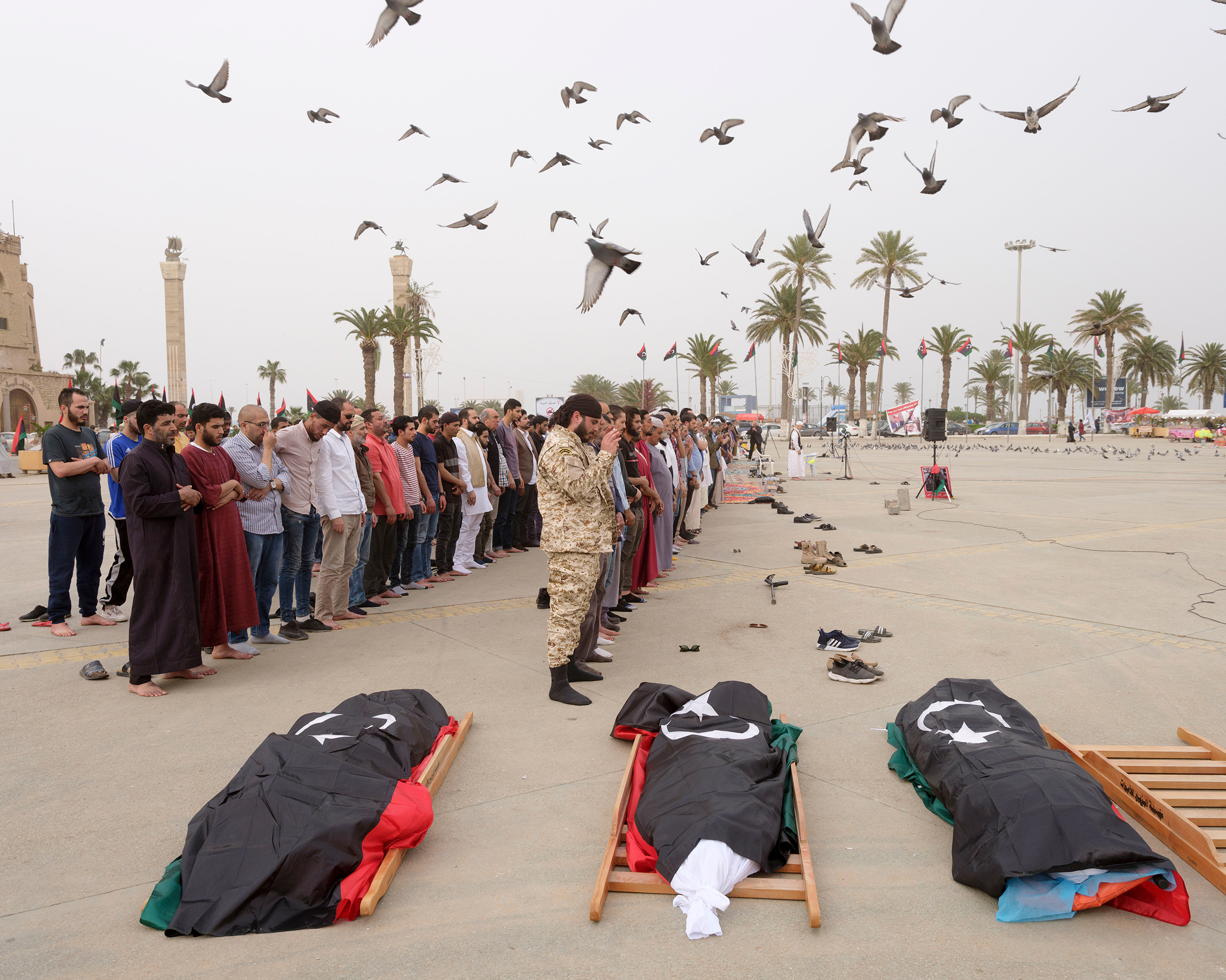 A funeral is held for three GNA fighters in Martyrs' Square in April. (Lorenzo Meloni—Magnum Photos)