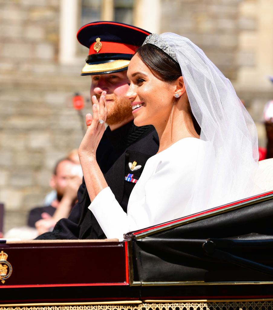 Prince Harry, Duke of Sussex and Meghan, Duchess of Sussex leave Windsor Castle in the Ascot Landau carriage during the procession after getting married at St George's Chapel, Windsor Castle on May 19, 2018 in Windsor, England. (James Devaney—GC Images)