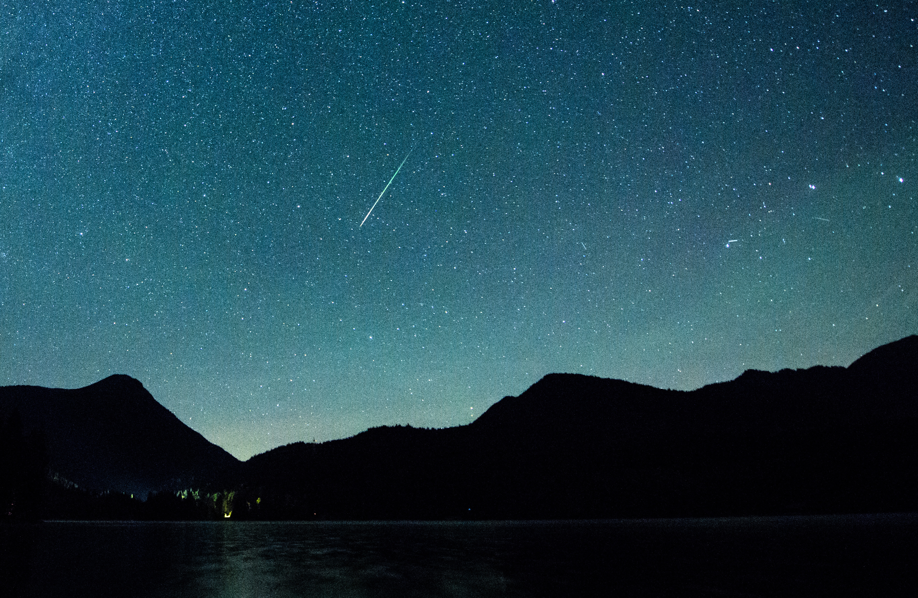 12 August 2018, Germany, Einsiedl: A shooting star appears next to the Milky Way in the sky above Walchensee. Every year in August numerous shooting stars can be seen in the shooting star showers of the Perseids. (picture alliance&mdash; Getty Images)