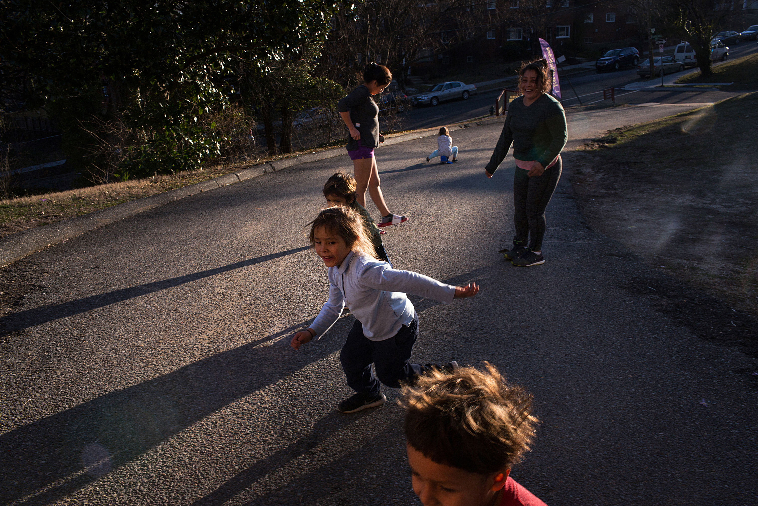 Maria, top-right, and Fanny play soccer with their respective children outside their house on March 12. (Federica Valabrega)