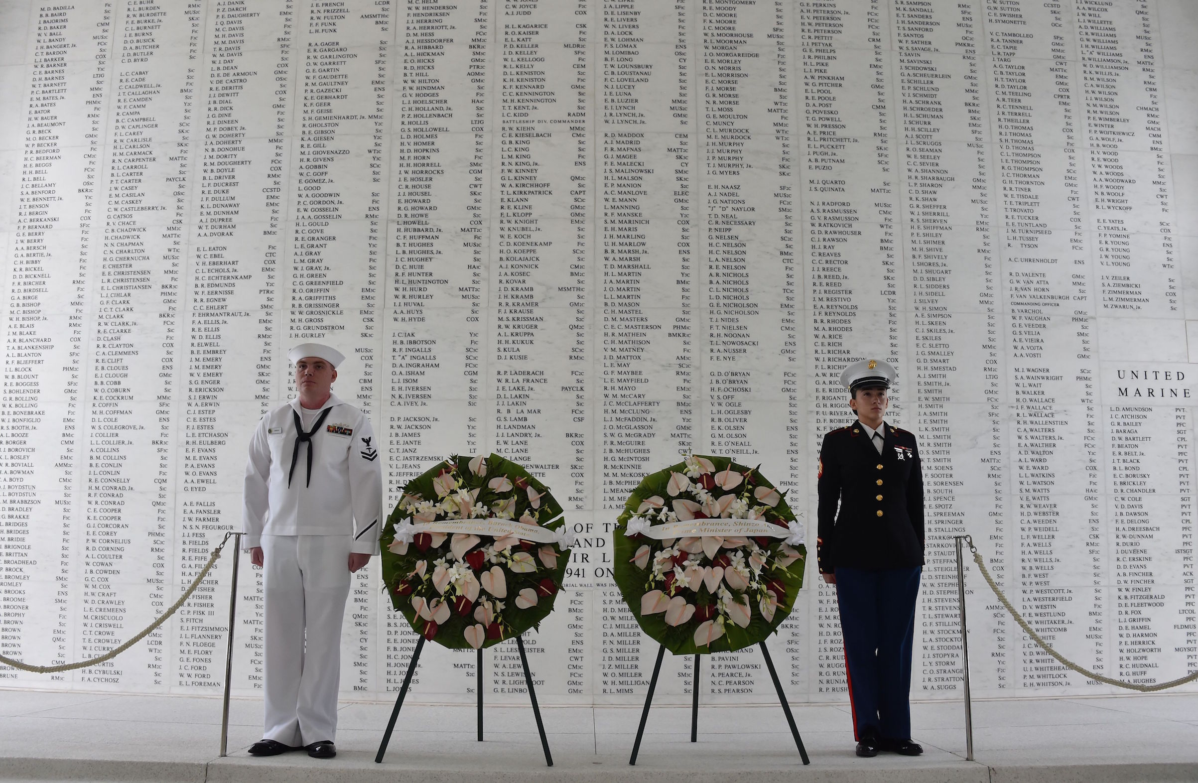 Two members of the U.S. military stand at attention after U.S. President Barack Obama and Japanese Prime Minister Shinzo Abe laid wreaths at the USS Arizona Memorial on Dec. 27, 2016 at Pearl Harbor in Honolulu. (Nicholas Kamm—AFP/Getty Images)
