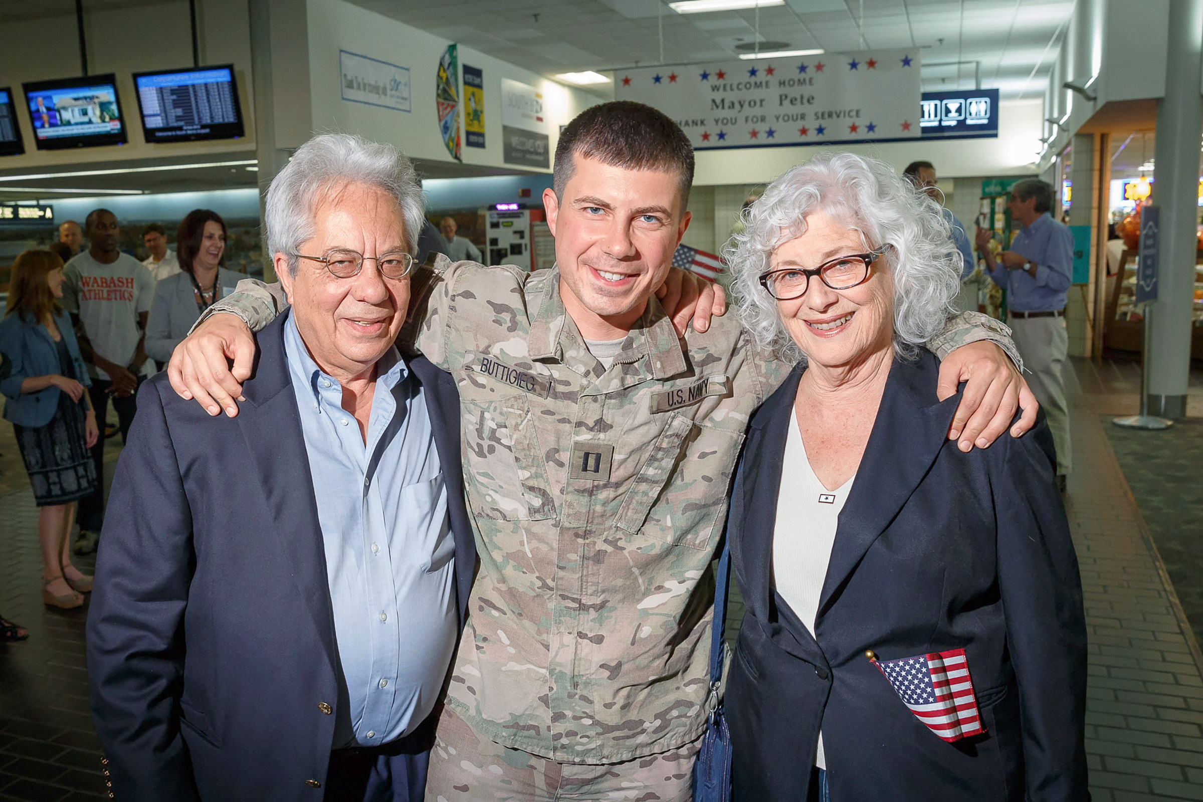 Lieutenant Buttigieg with his parents Joseph and Anne when he returned to South Bend after six months in Afghanistan, 2014. (Courtesy Pete Buttigieg)