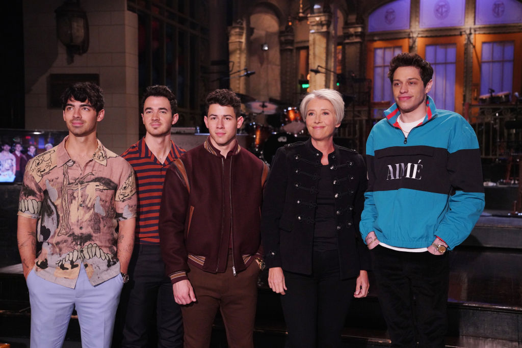 Pictured left to right: Joe Jonas, Kevin Jonas, and Nick Jonas of musical guest the Jonas Brothers, with host Emma Thompson and Pete Davidson in Studio 8H on Thursday, May 9, 2019 (Rosalind O'Connor—NBC/NBCU Photo Bank/Getty Images)