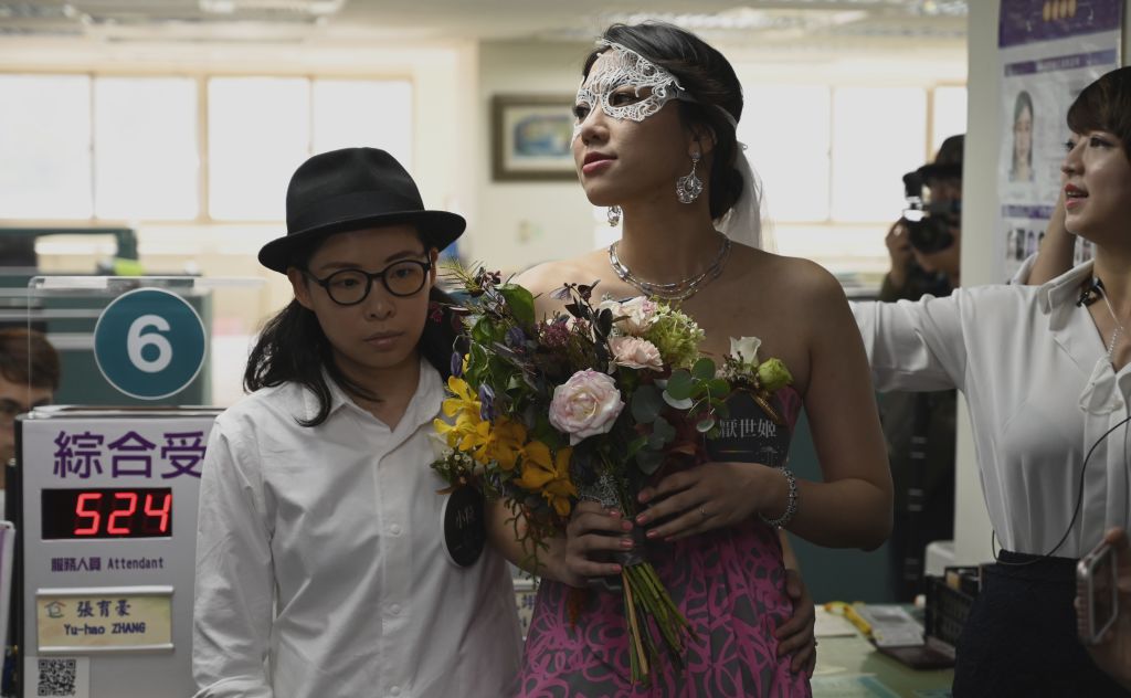 Gay couple Cynical Chick (L) and Li Ying-Chien wait for wedding register at the Household Registration Office in Shinyi district in Taipei on May 24, 2019. (Sam Yeh—AFP/Getty Images)