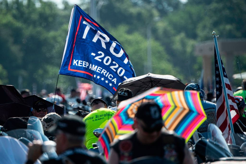 A "Trump 2020" flag is seen as hundreds of thousands of bikers gather on the Pentagon Parking before taking part in the "Rolling thunder" parade, part of the Memorial weekend honouring war veterans in Arlington, near Washington, on May 26 2019. - Thousands of bikers converged on the US capital for what is billed as their last national "Rolling Thunder" ride in honor of missing American soldiers on Memorial Day weekend. They got a boost from President Donald Trump himself, who tweeted Saturday that he would like to help maintain the event, which is bogged down in a dispute over costs. (ERIC BARADAT—AFP/Getty Images)