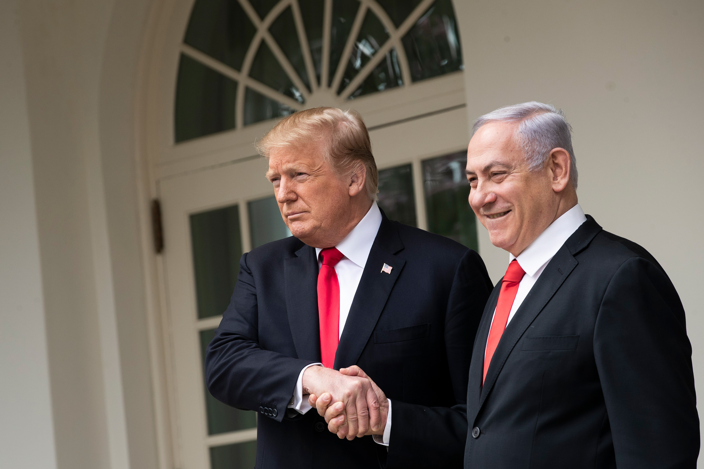 President Donald Trump and Prime Minister of Israel Benjamin Netanyahu shake hands while walking through the colonnade prior to an Oval Office meeting at the White House March 25, 2019 in Washington, D.C. (Drew Angerer/Getty Images)