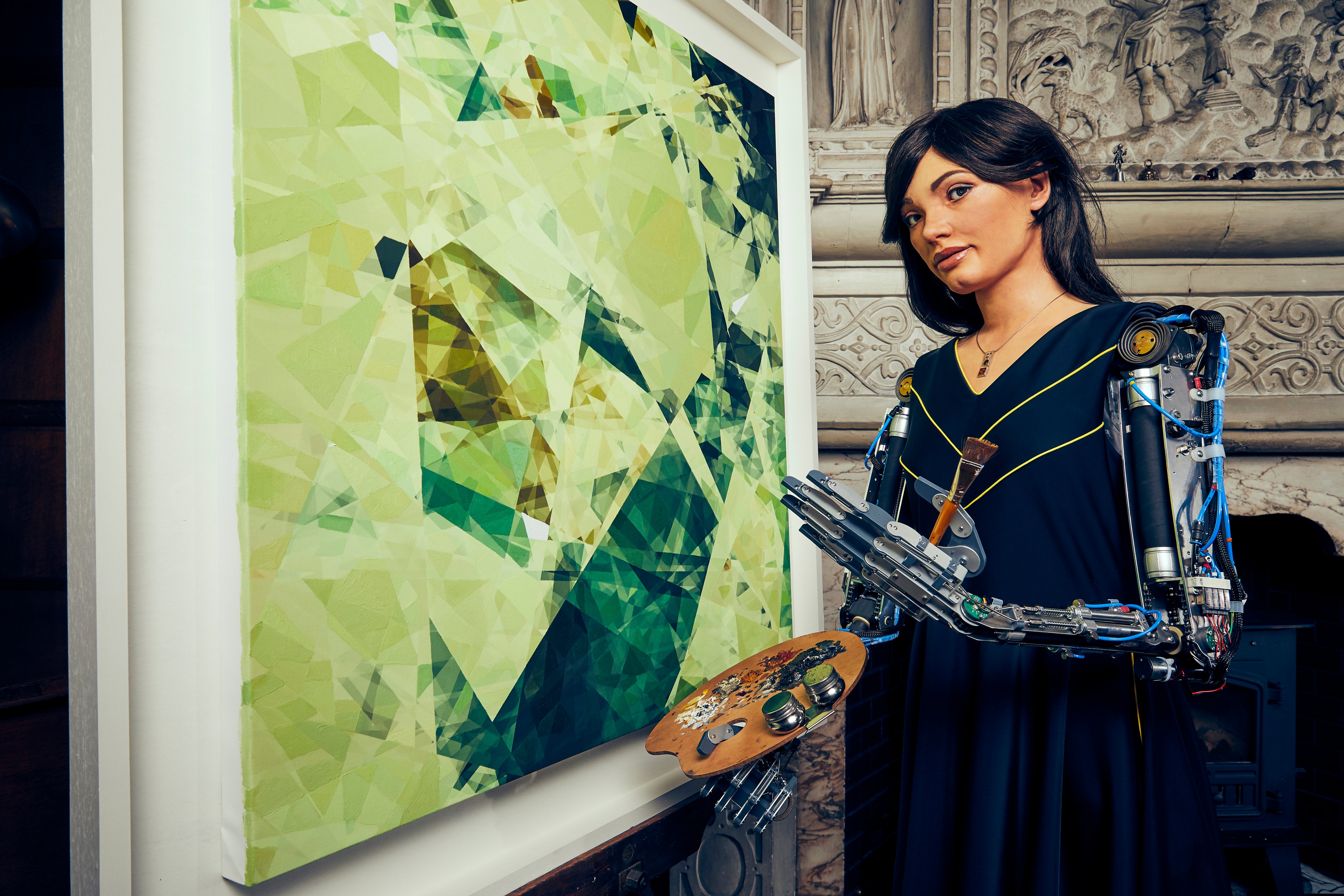 Ai-Da Robot with a painting created by her response to an oak tree