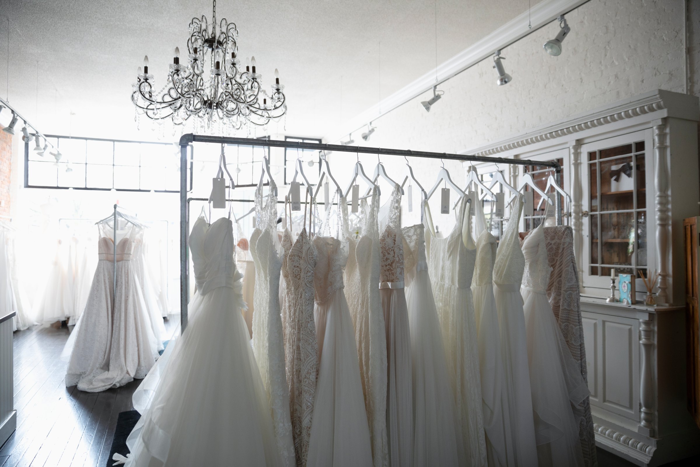 Wedding dresses on rack in bridal boutique