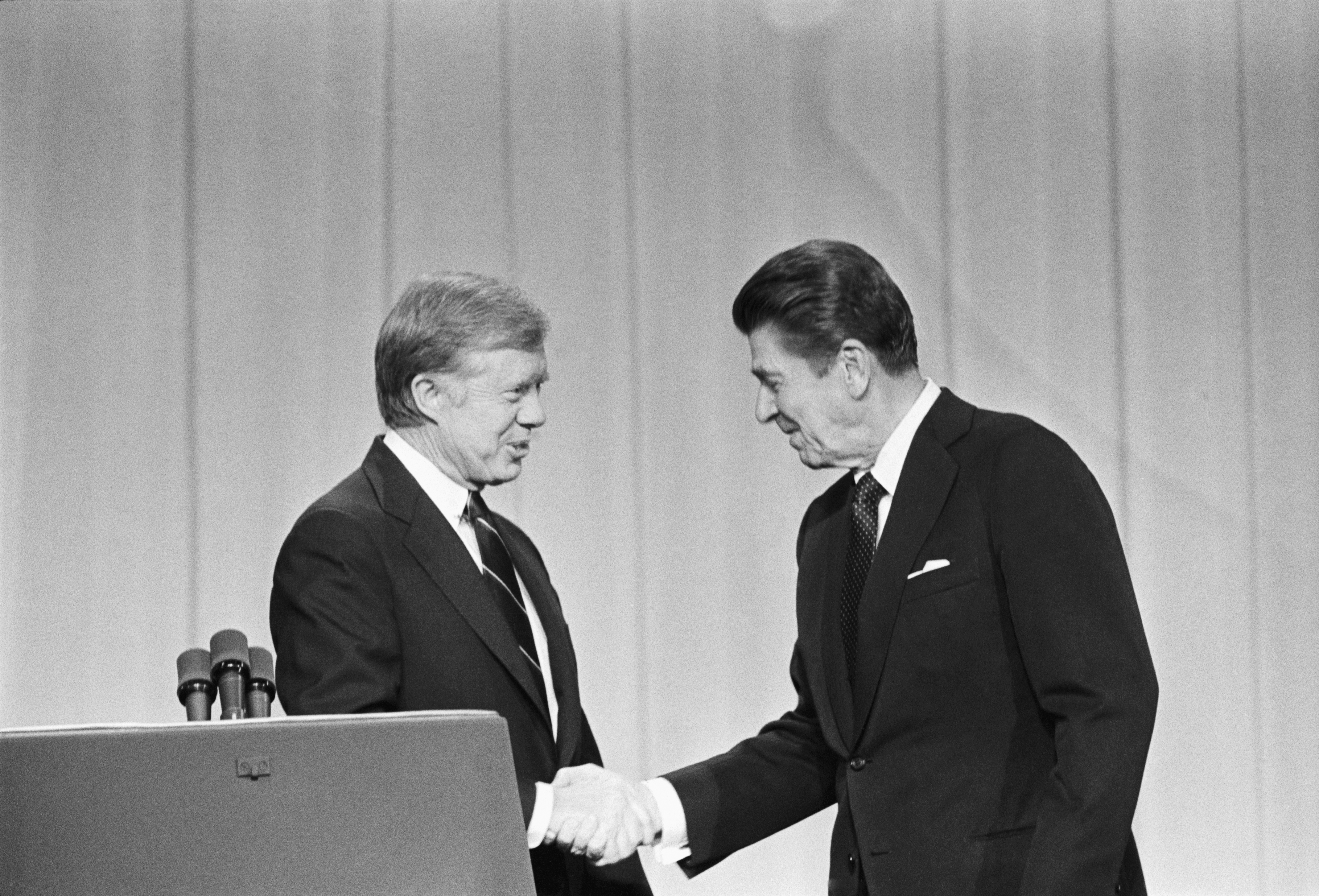 President Jimmy Carter and his Republican challenger, Ronald Reagan, shake hands as they greet one another before their debate on the stage of the Music Hall in Cleveland, Ohio. (Bettmann—Bettmann Archive)