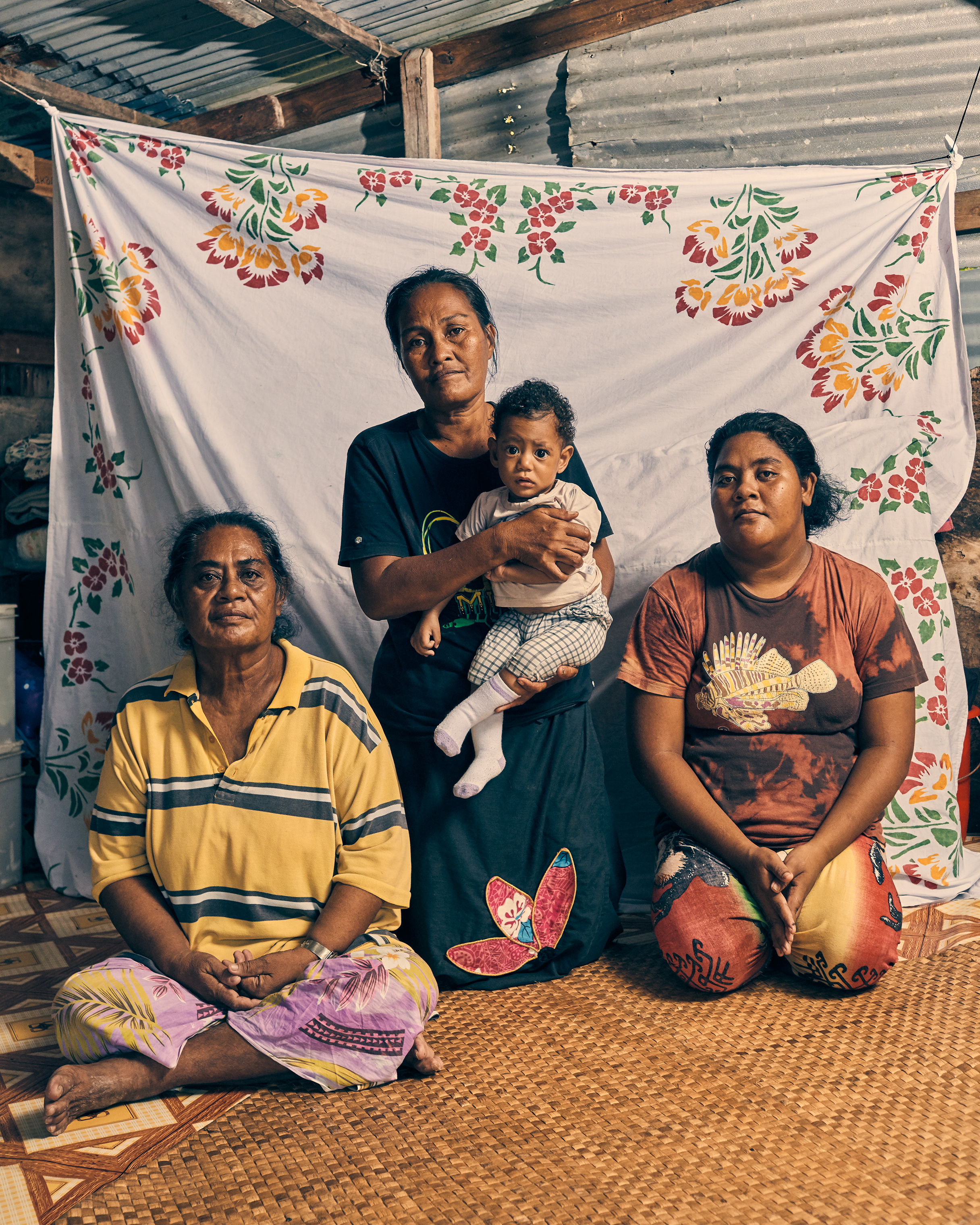Members of the Salesa family, photographed in Funafuti, Tuvalu, on May 17. Their home floods four or five times a month, when the high tide comes in.