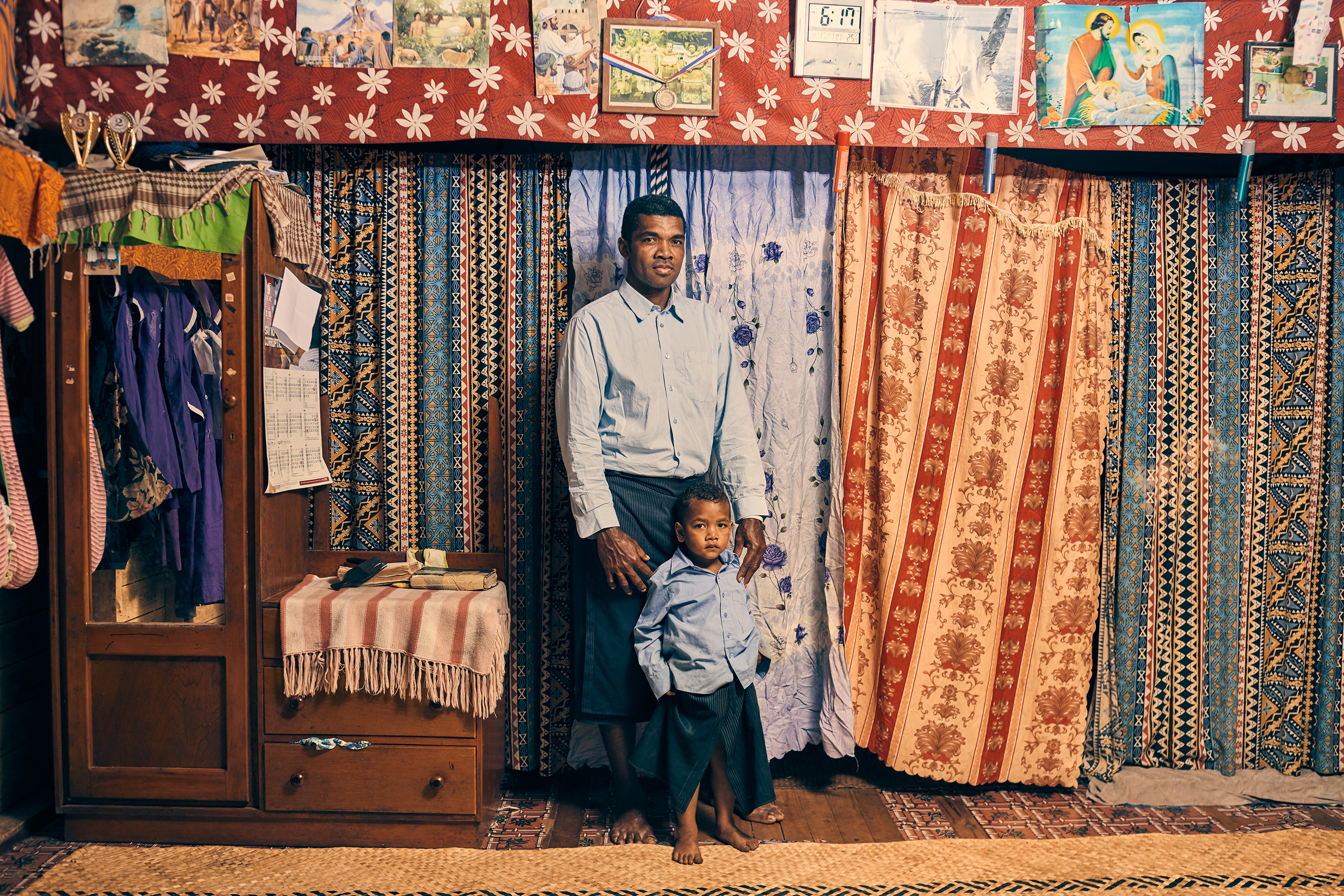 Apisai Logaivau and his son Simione Botu in their home in the relocated village. Logaivau lives here with his wife and four other children. (Christopher Gregory for TIME)