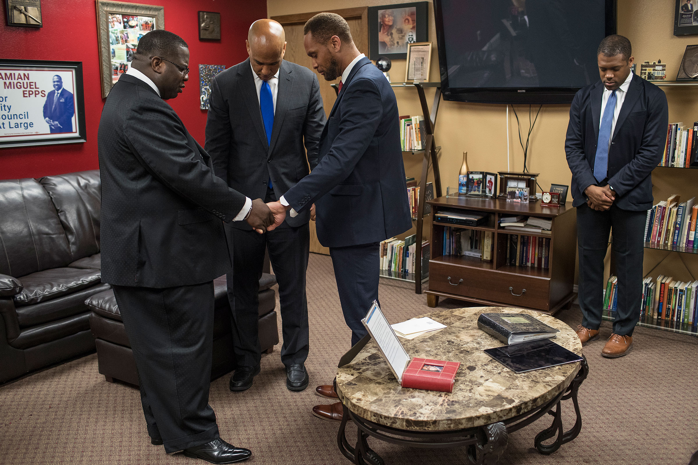 Pastor Dr. Damian Miguel Epps, Senator Cory Booker, and Linn County Supervisor Stacey Walker pray before the Youth Empowerment Day service at Mt. Zion Missionary Baptist Church in Cedar Rapids, Iowa on June 9. (Danny Wilcox Frazier—VII for TIME)