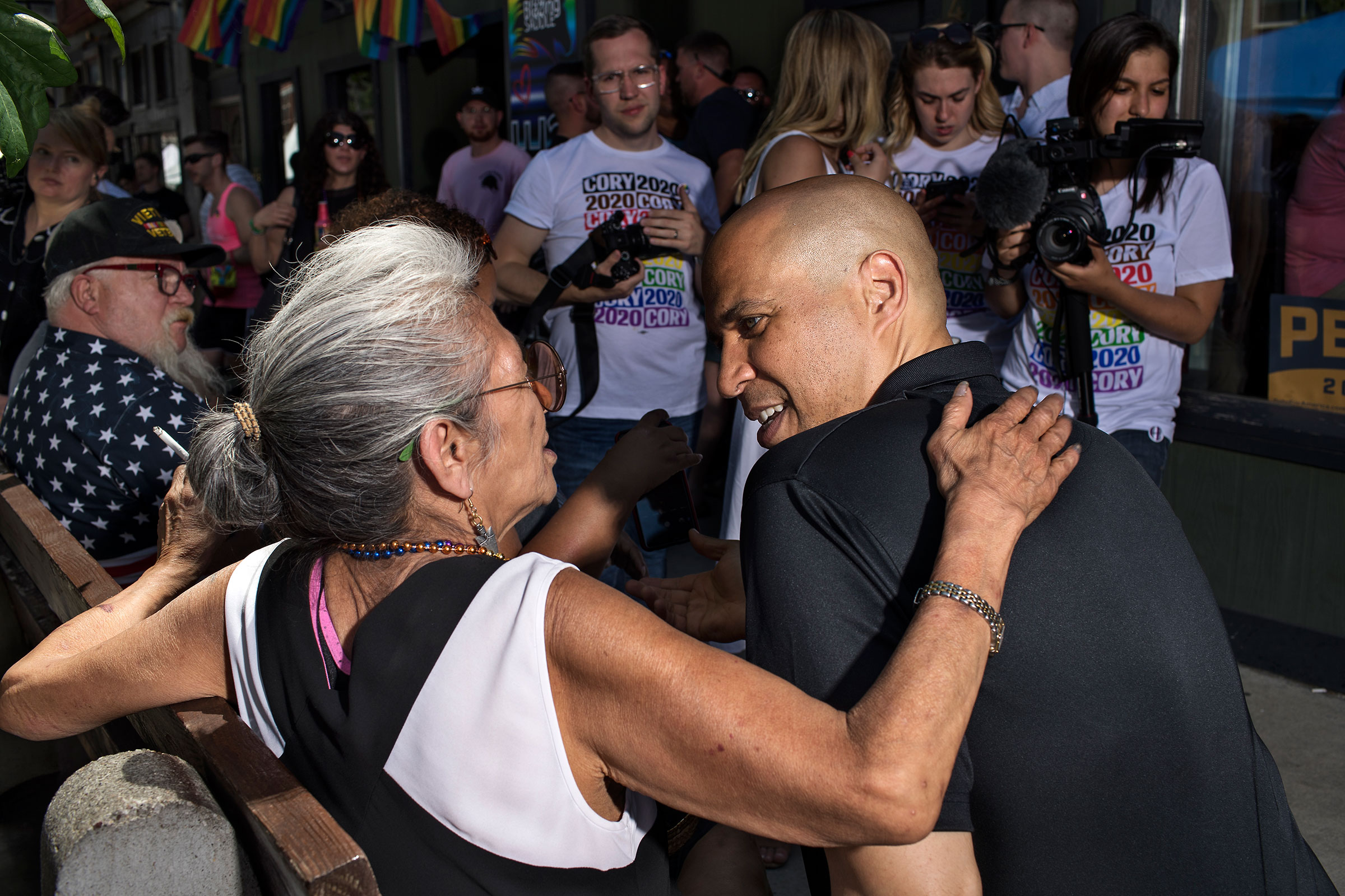 Booker speaks with a community member in Des Moines' East Village neighborhood during the Capital City Pride Festival on June 8. (Danny Wilcox Frazier—VII for TIME)