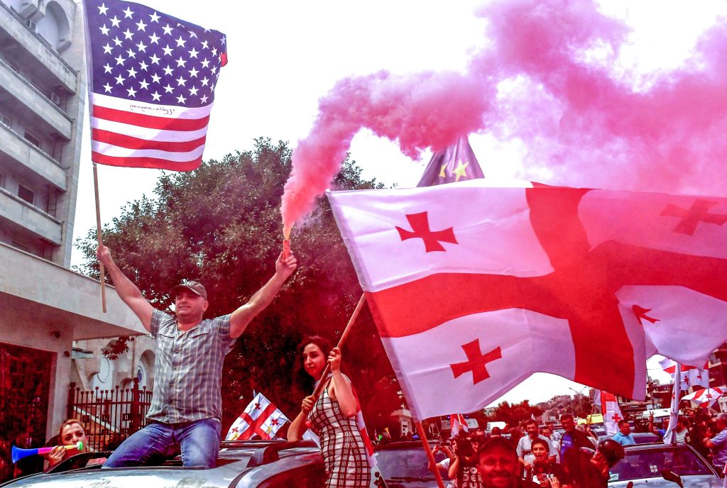 Protesters waive the Georgian and American flags during a rally in Tbilisi, on June 24, 2019. (Vano Shlamov —AFP/Getty Images)