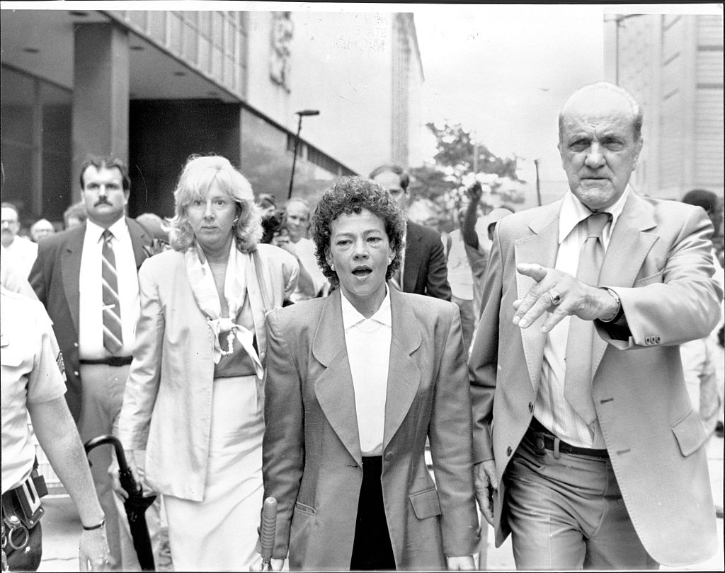 Prosecutors Linda Fairstein (left) and Elizabeth Lederer (right) are escorted from court after summations at lunchtime under heavy security against jeering demonstrators on August 06, 1990. (New York Post Archives—The New York Post via Getty Images)