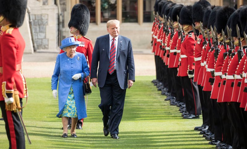 The Queen walks with President Trump as they inspect the Coldstream guards at Windsor castle on July 13, 2018.