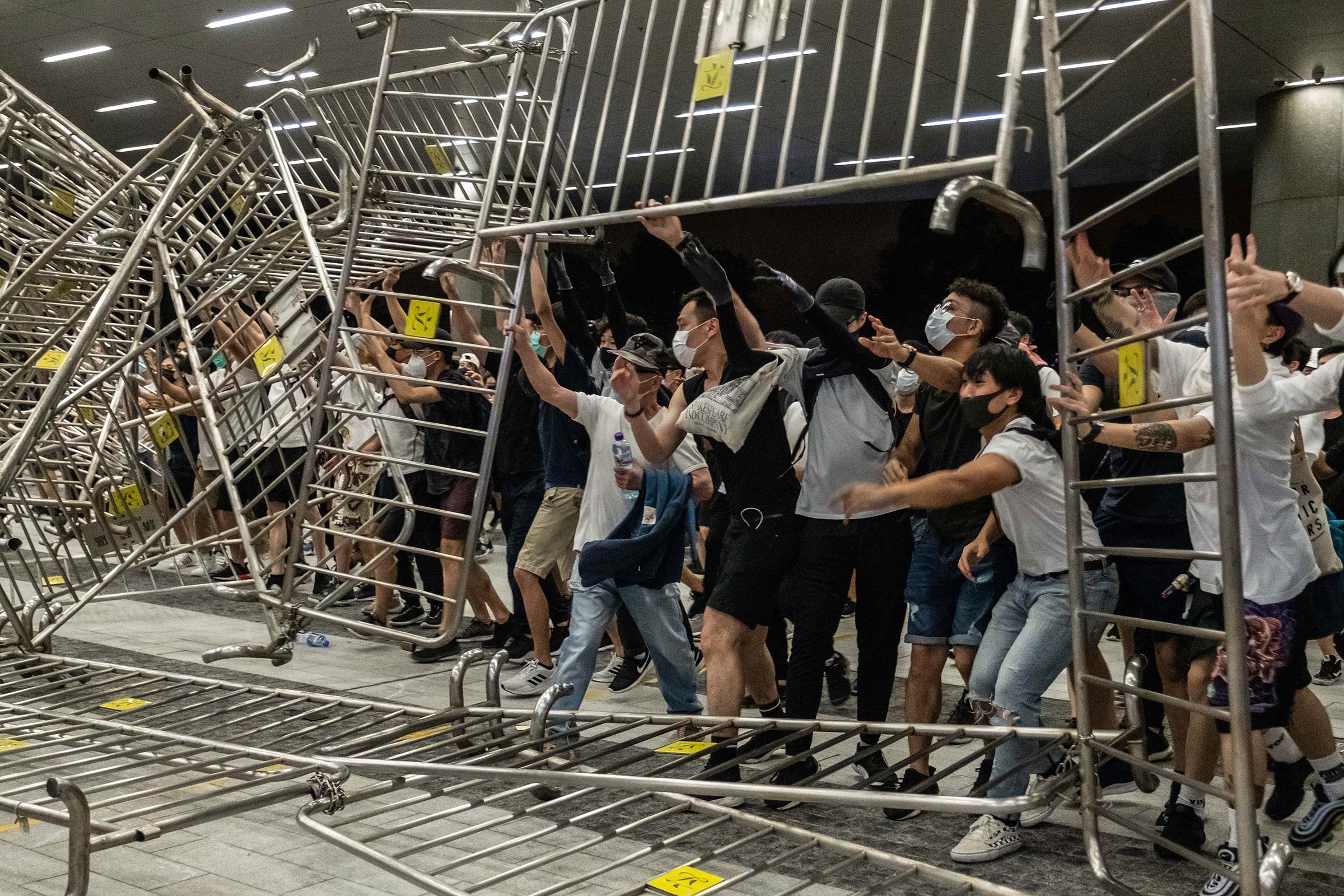 Demonstrators overturn metal barriers on June 10, as protests against the extradition law turn violent. (Lam Yik Fei—The New York Times/Redux)