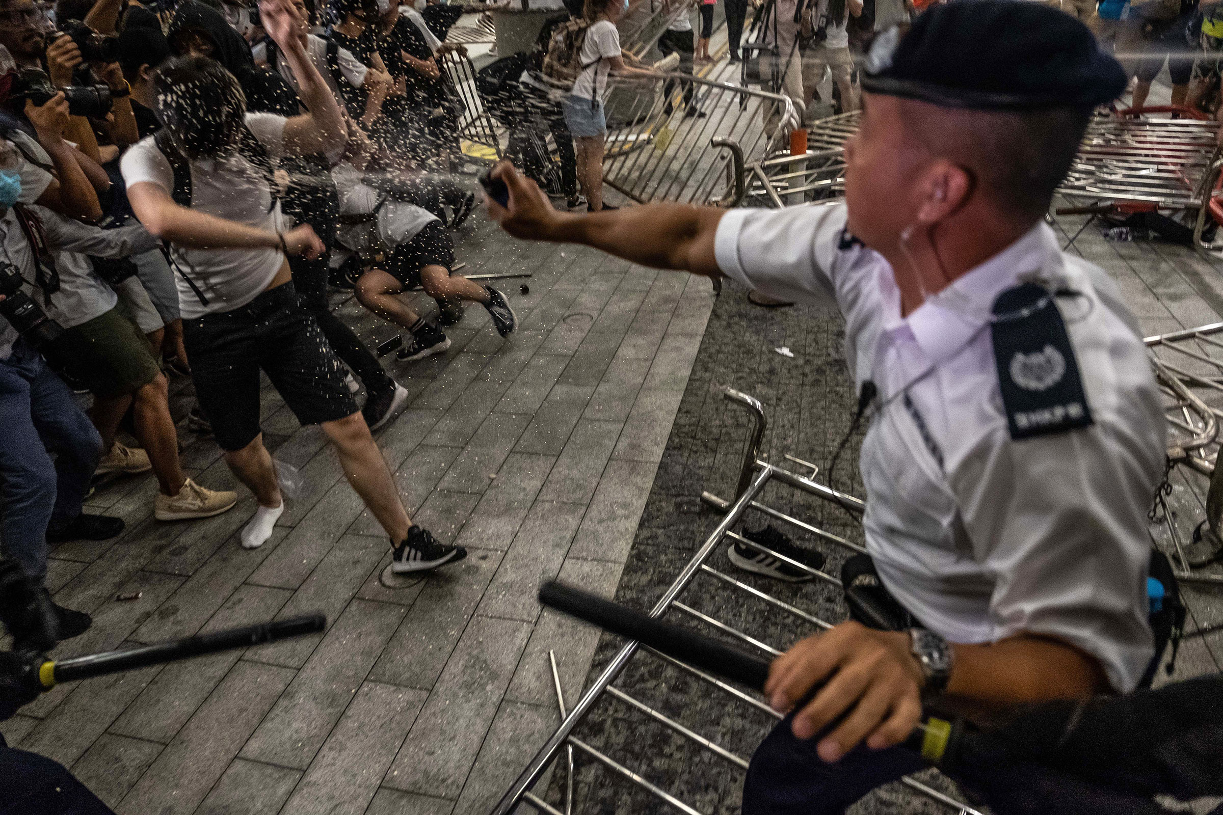 A police officer pepper-sprays demonstrators during a protest against the extradition law proposal on June 10. (Lam Yik Fei—The New York Times/Redux)