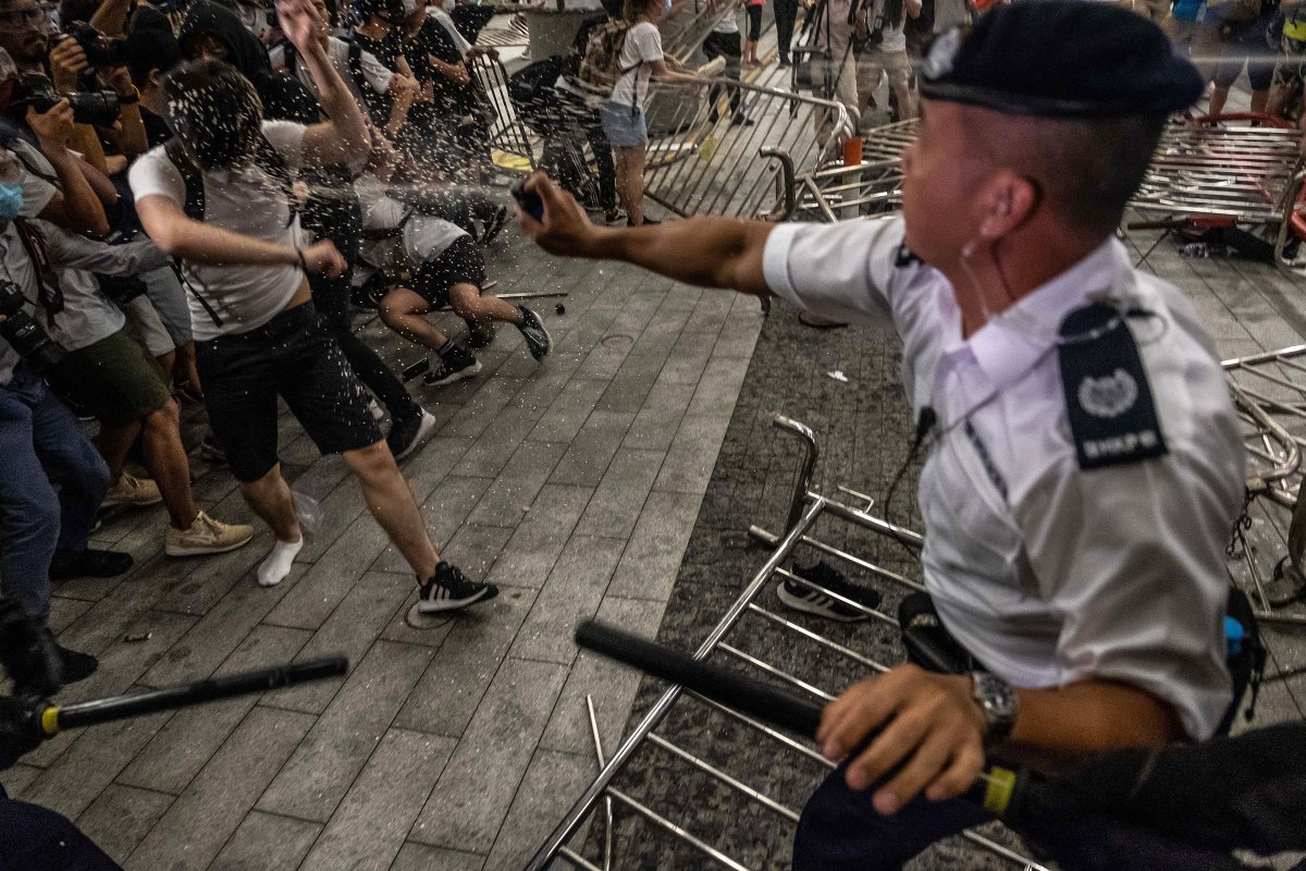A police officer pepper-sprays demonstrators during a protest against the extradition law proposal on June 10.