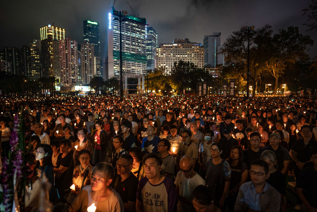 People hold candles as they take part in a candlelight vigil at Victoria Park in Hong Kong on on June 4, 2019. (Anthony Kwan—Getty Images)