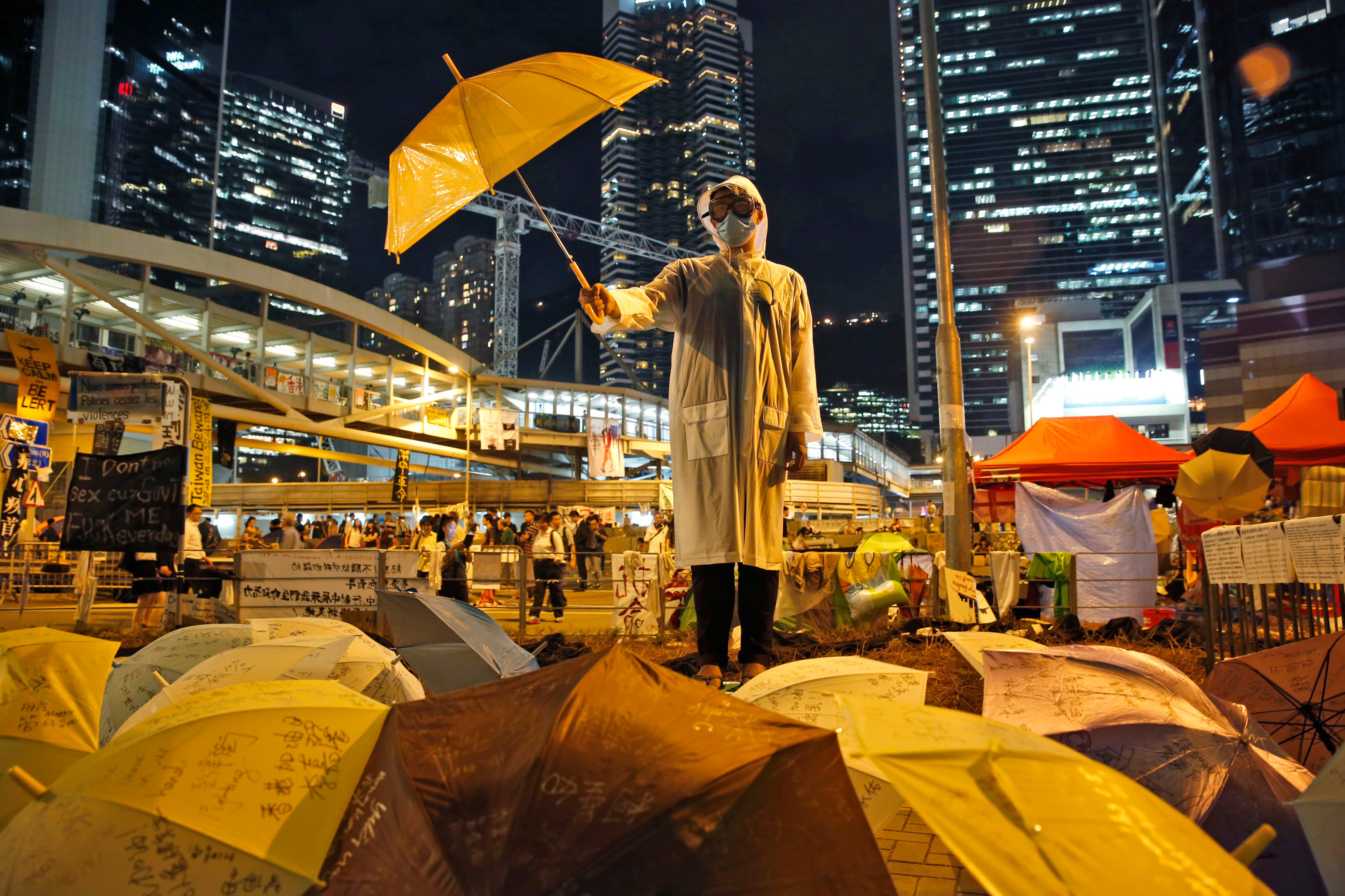 A protester holds an umbrella on a main road in the occupied areas outside government headquarters in Hong Kong's Admiralty on Oct. 9, 2014. (Kin Cheung—AP)