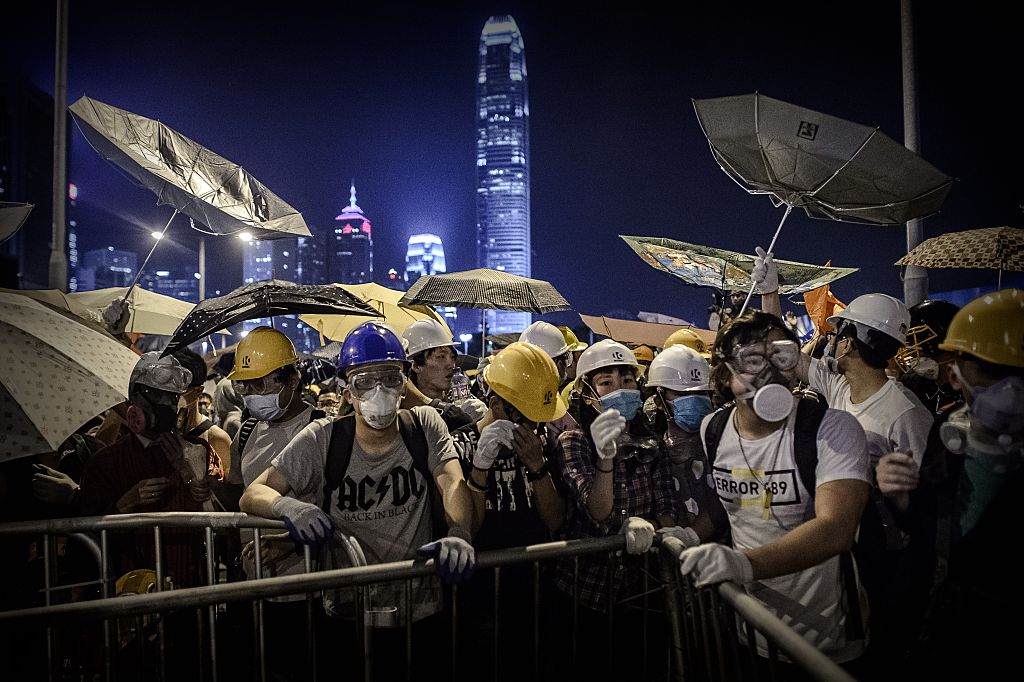 Pro-democracy protesters face police forces during clashes at a pro-democracy rally in the Admiralty district of Hong Kong on Nov. 30, 2014. (Philippe Lopez—AFP/Getty Images)