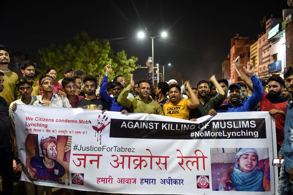 Indian Muslims hold a banner as they protest against the mob lynching of Tabrez Ansari in the Jharkhand state, in Ahmedabad on June 26, 2019. (Sam Panthaky—AFP/Getty Images)